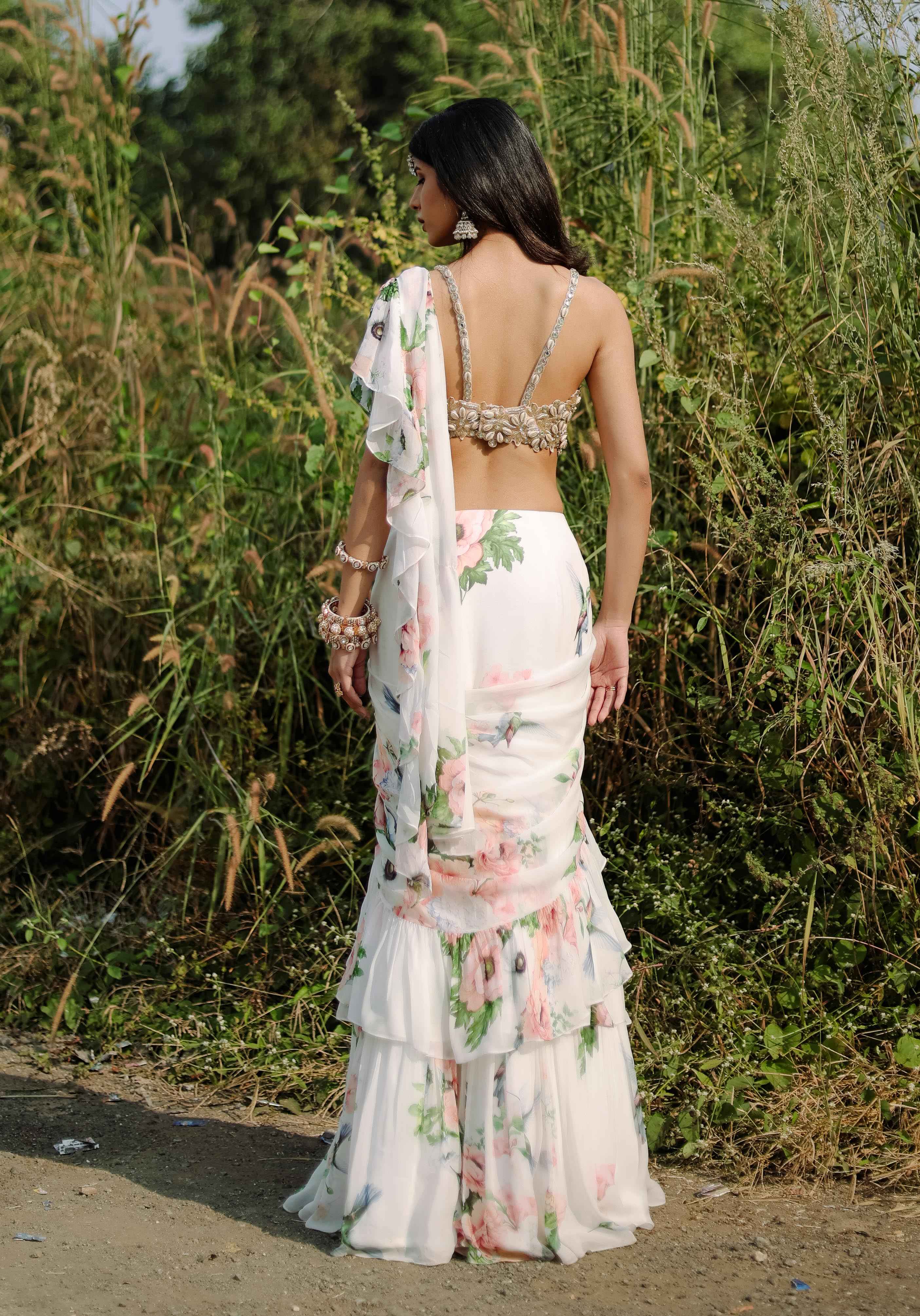 A model showcasing White Floral Printed Ruffle Predraped Saree Set by Foram Patel from Foram Patel's collection