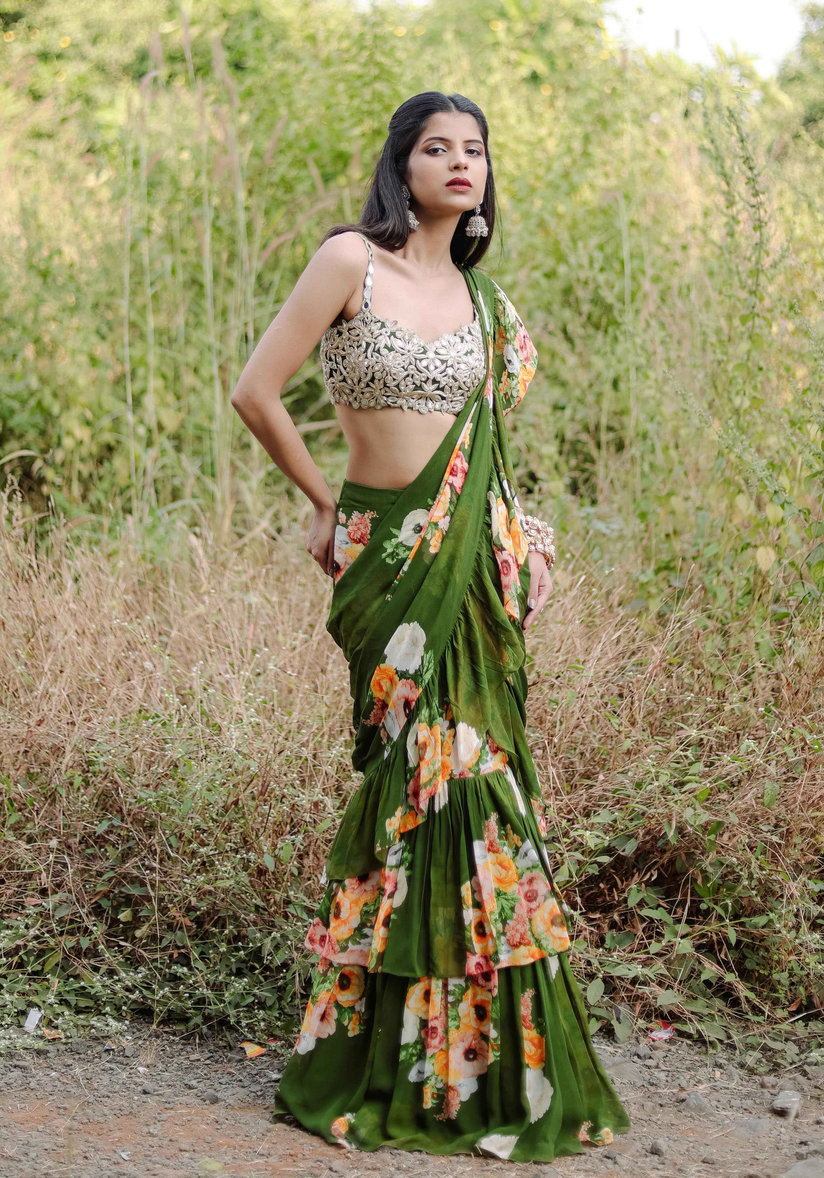A model showcasing Green Floral Printed Rufflepredraped Saree Set by Foram Patel from Foram Patel's collection