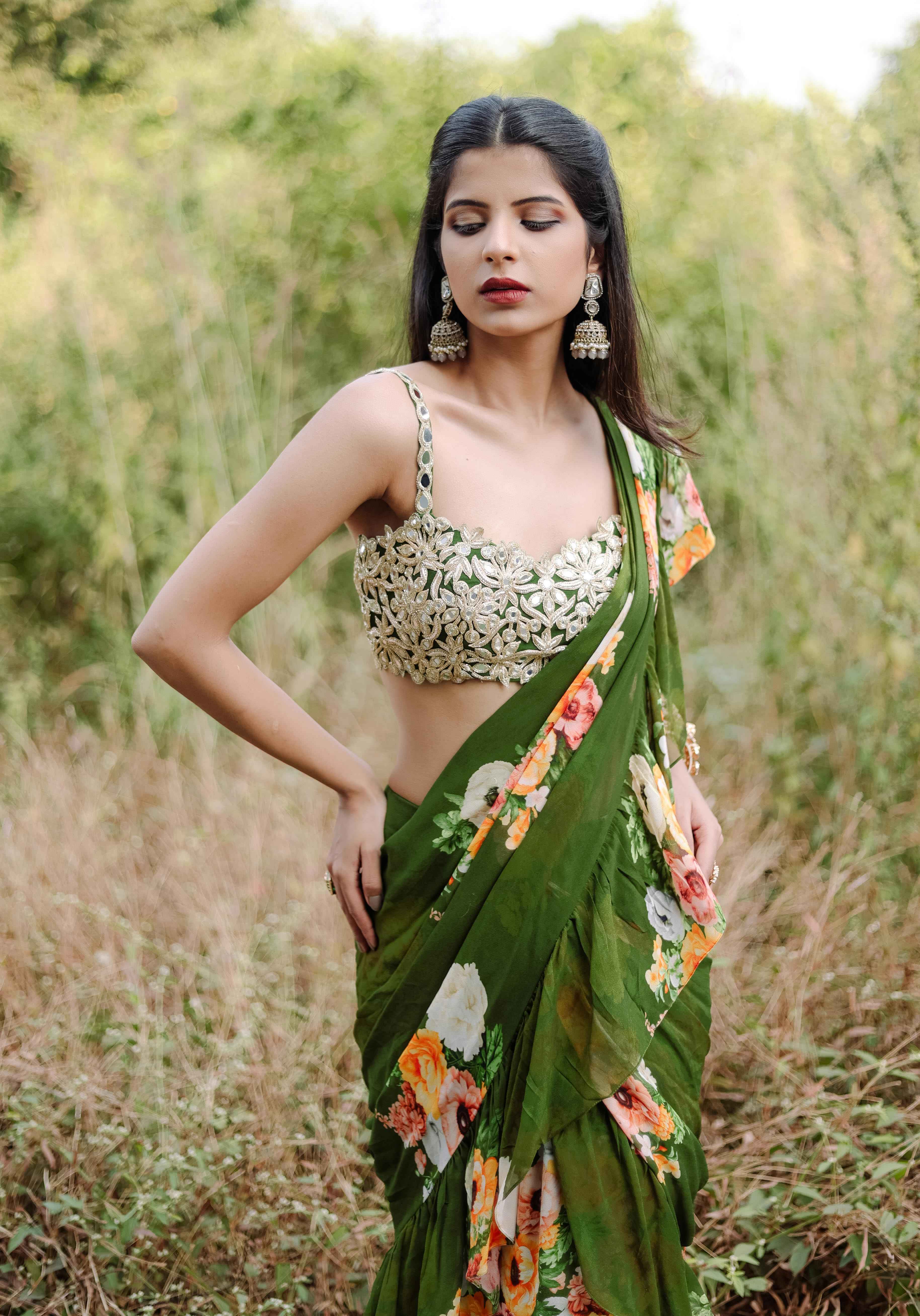 A model showcasing Green Floral Printed Rufflepredraped Saree Set by Foram Patel from Foram Patel's collection