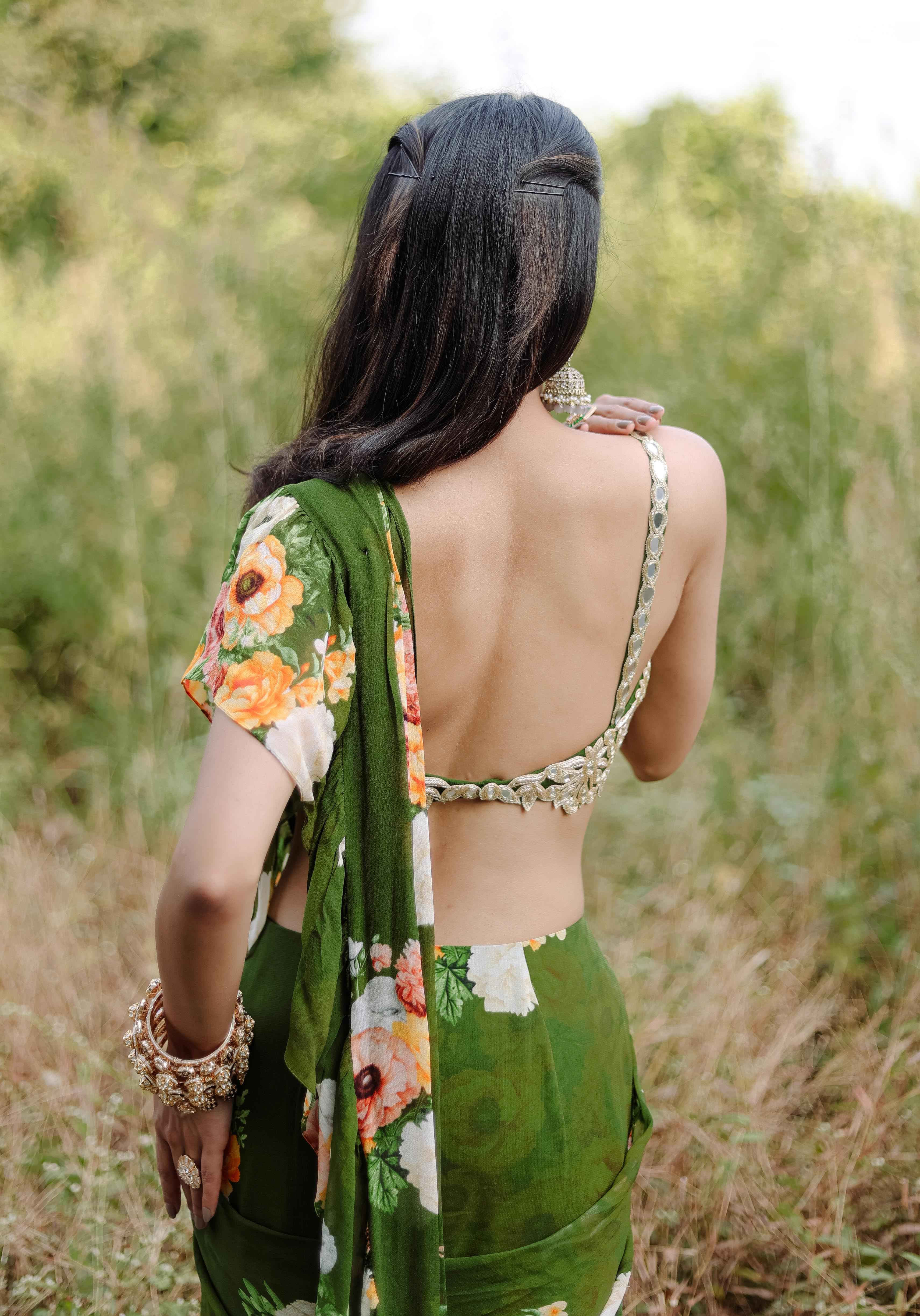 A model showcasing Green Floral Printed Rufflepredraped Saree Set by Foram Patel from Foram Patel's collection