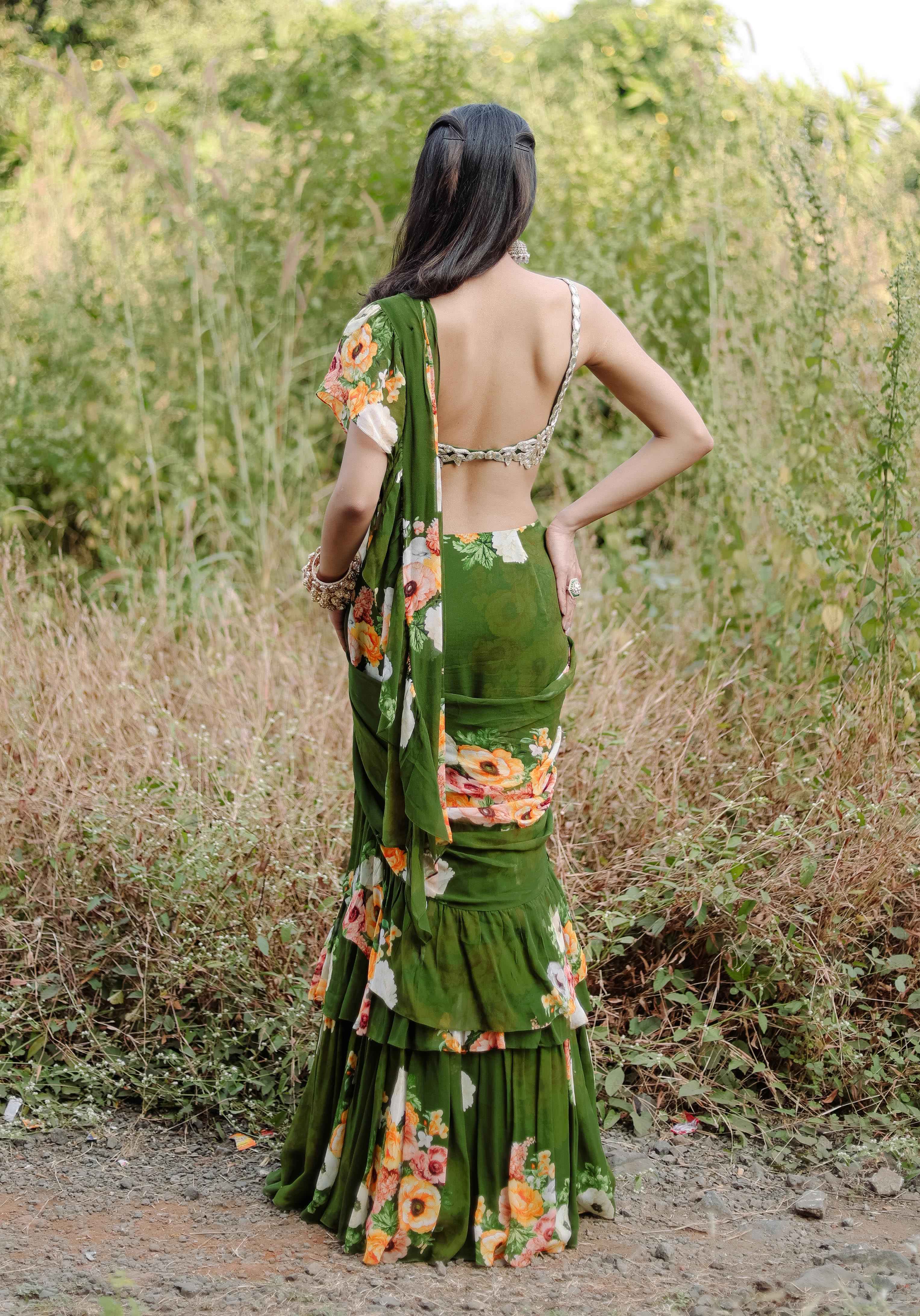 A model showcasing Green Floral Printed Rufflepredraped Saree Set by Foram Patel from Foram Patel's collection