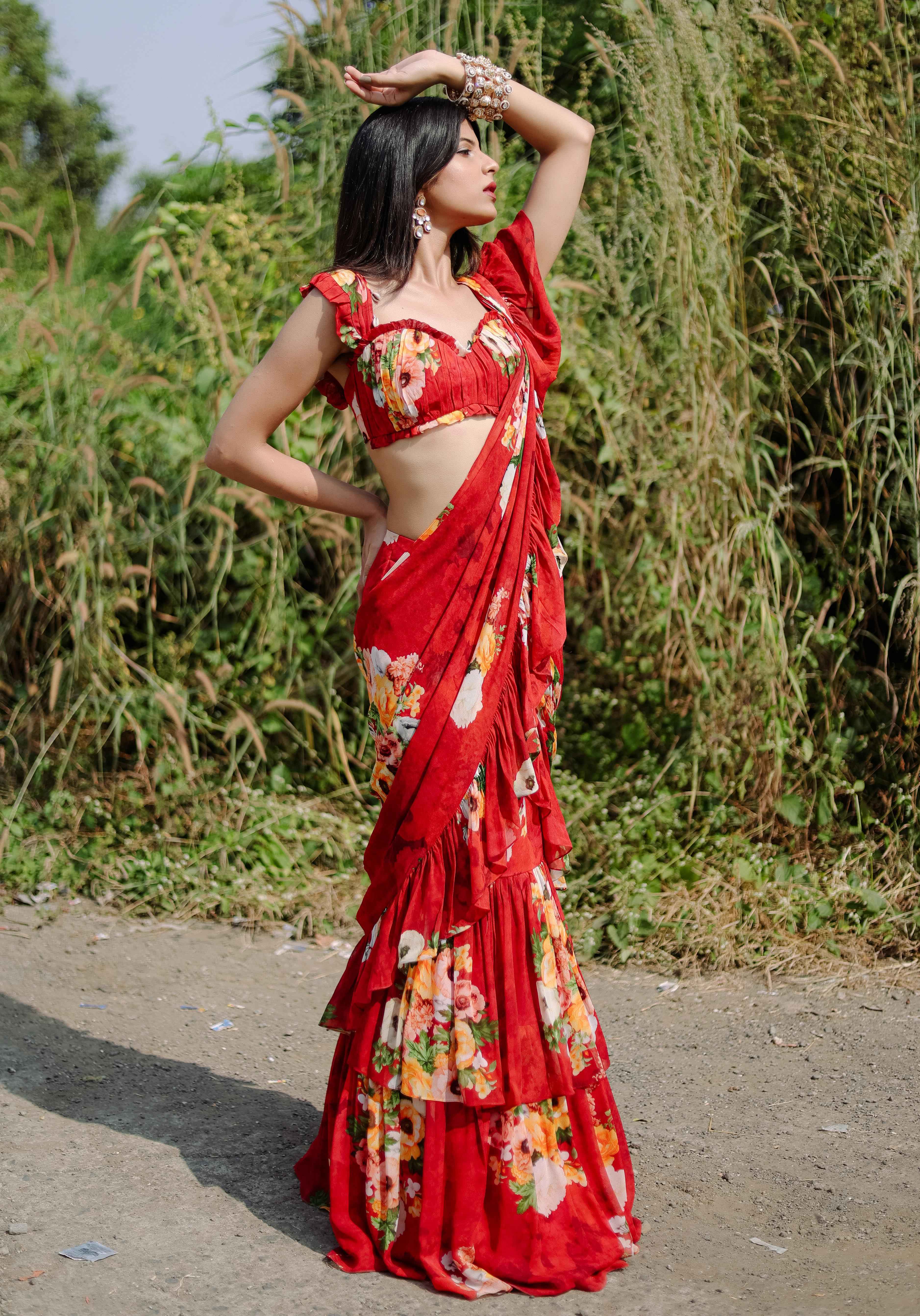 A model showcasing Red Floral Printed Predraped Ruffle Saree Set by Foram Patel from Foram Patel's collection