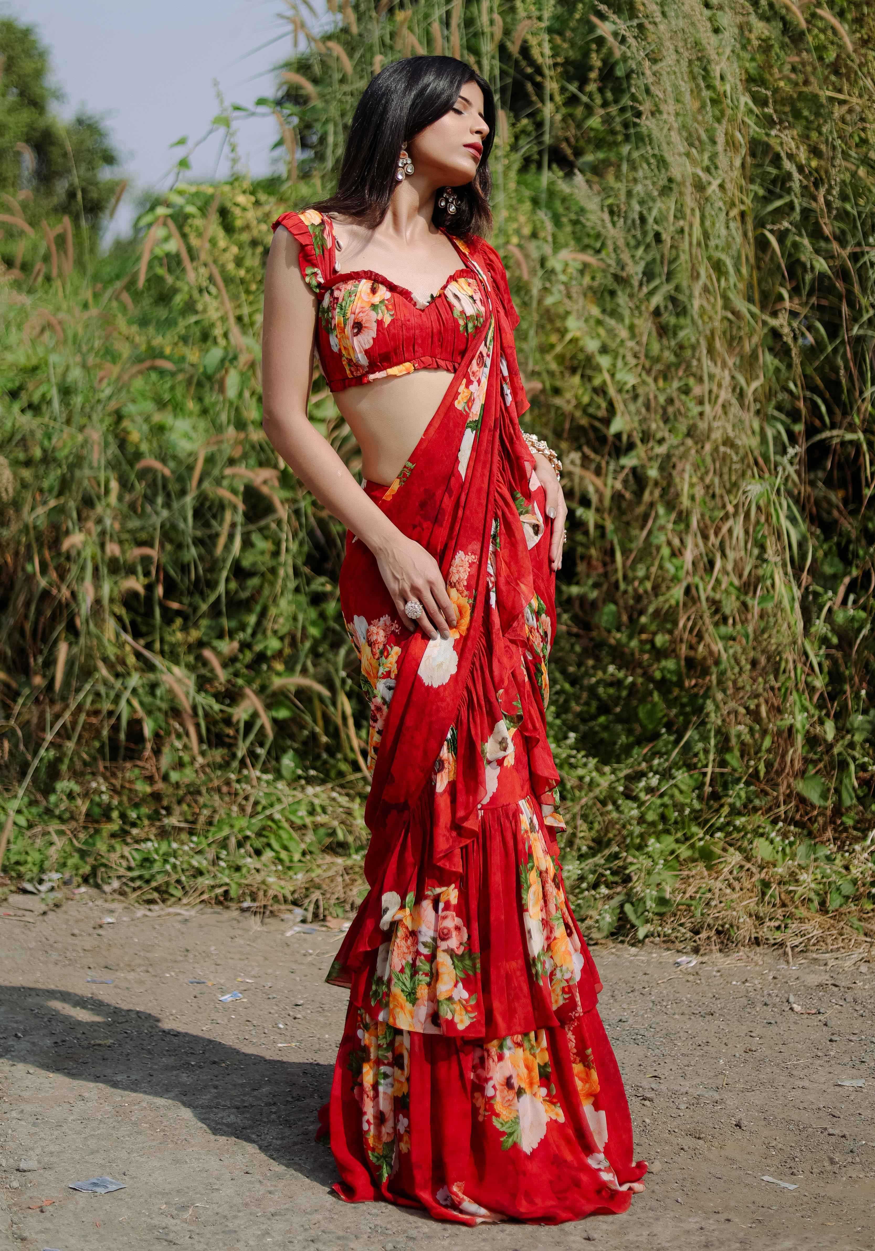 A model showcasing Red Floral Printed Predraped Ruffle Saree Set by Foram Patel from Foram Patel's collection