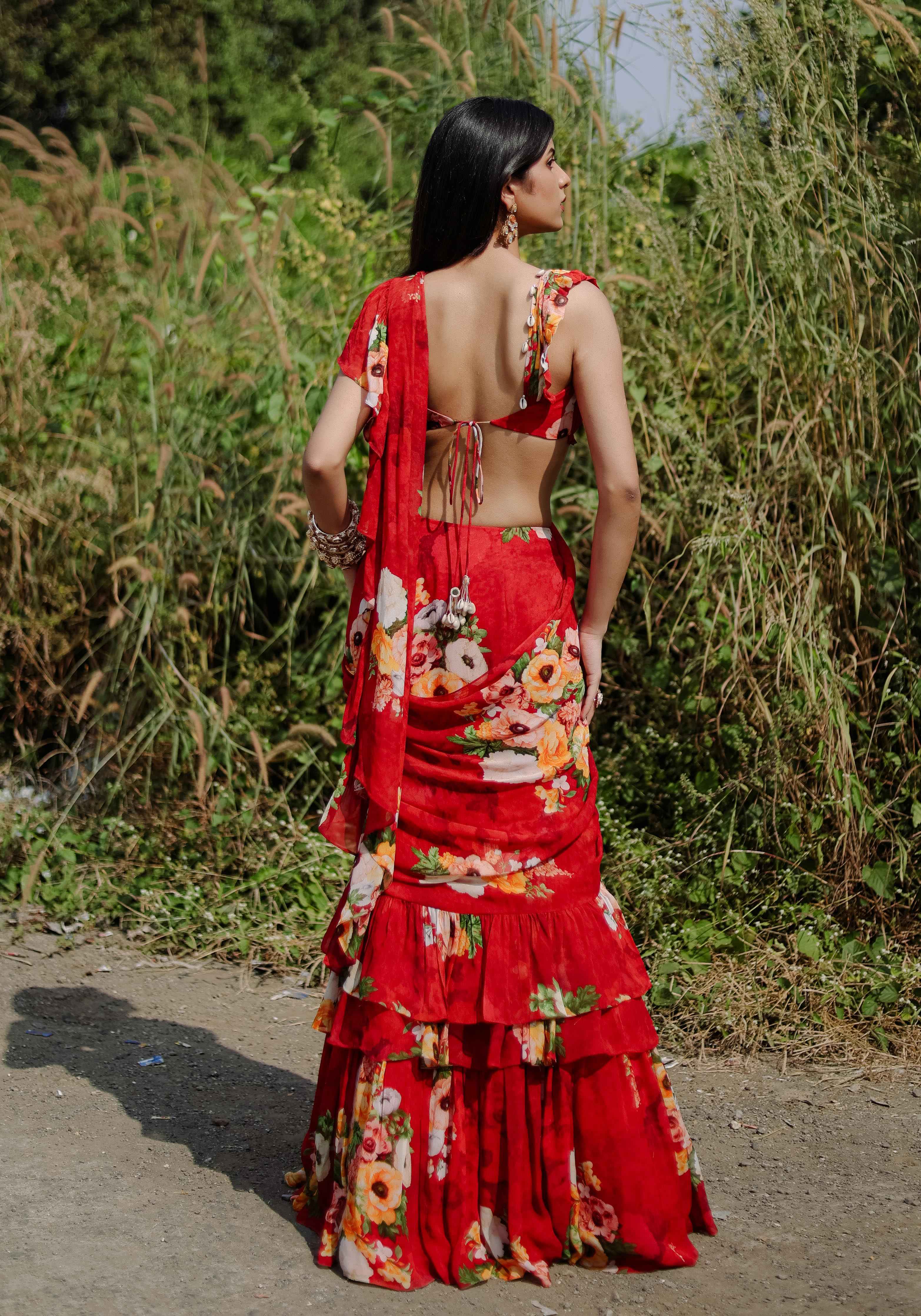 A model showcasing Red Floral Printed Predraped Ruffle Saree Set by Foram Patel from Foram Patel's collection