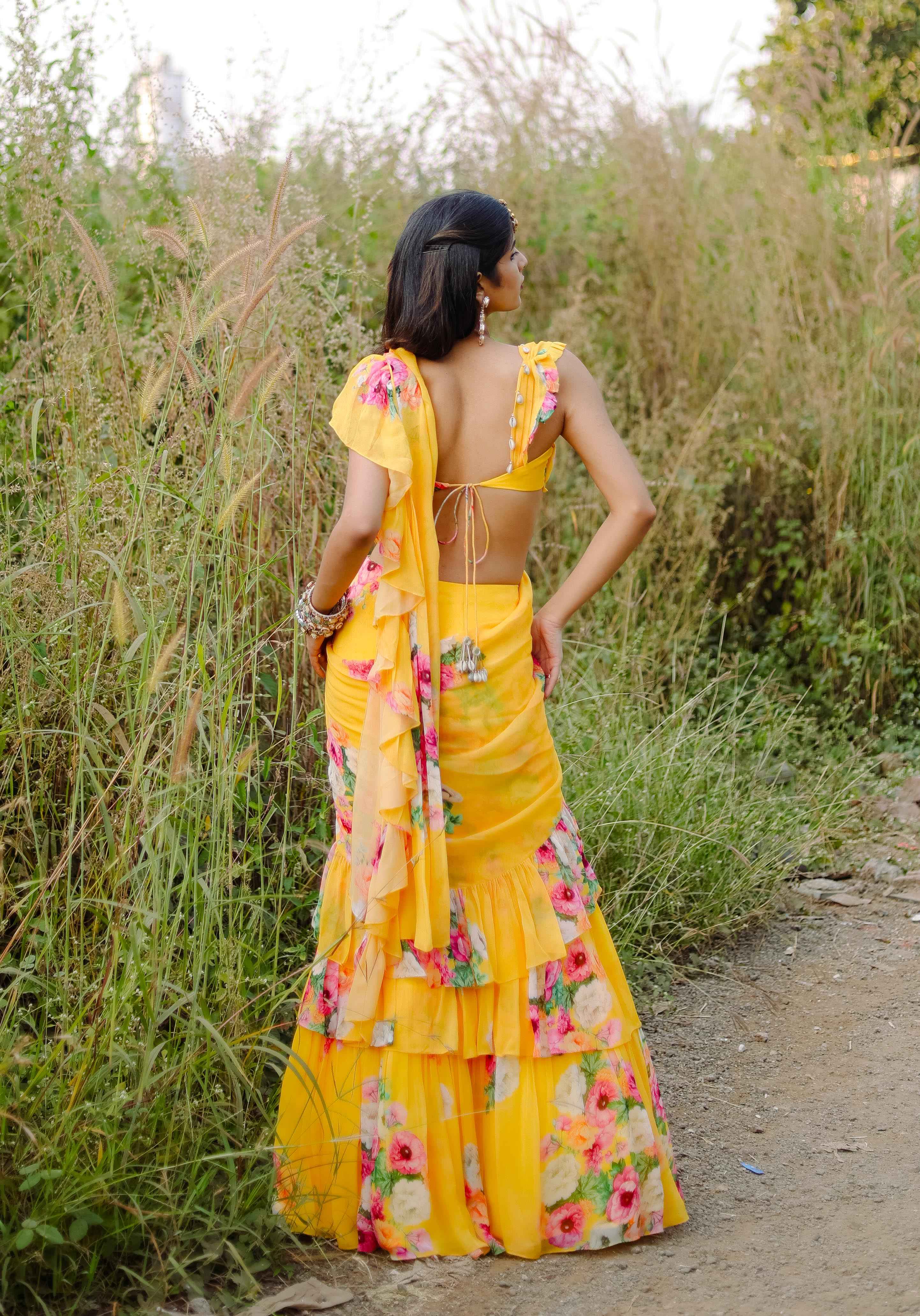 A model showcasing Yellow Floral Printed Predraped Ruffle Saree Set by Foram Patel from Foram Patel's collection
