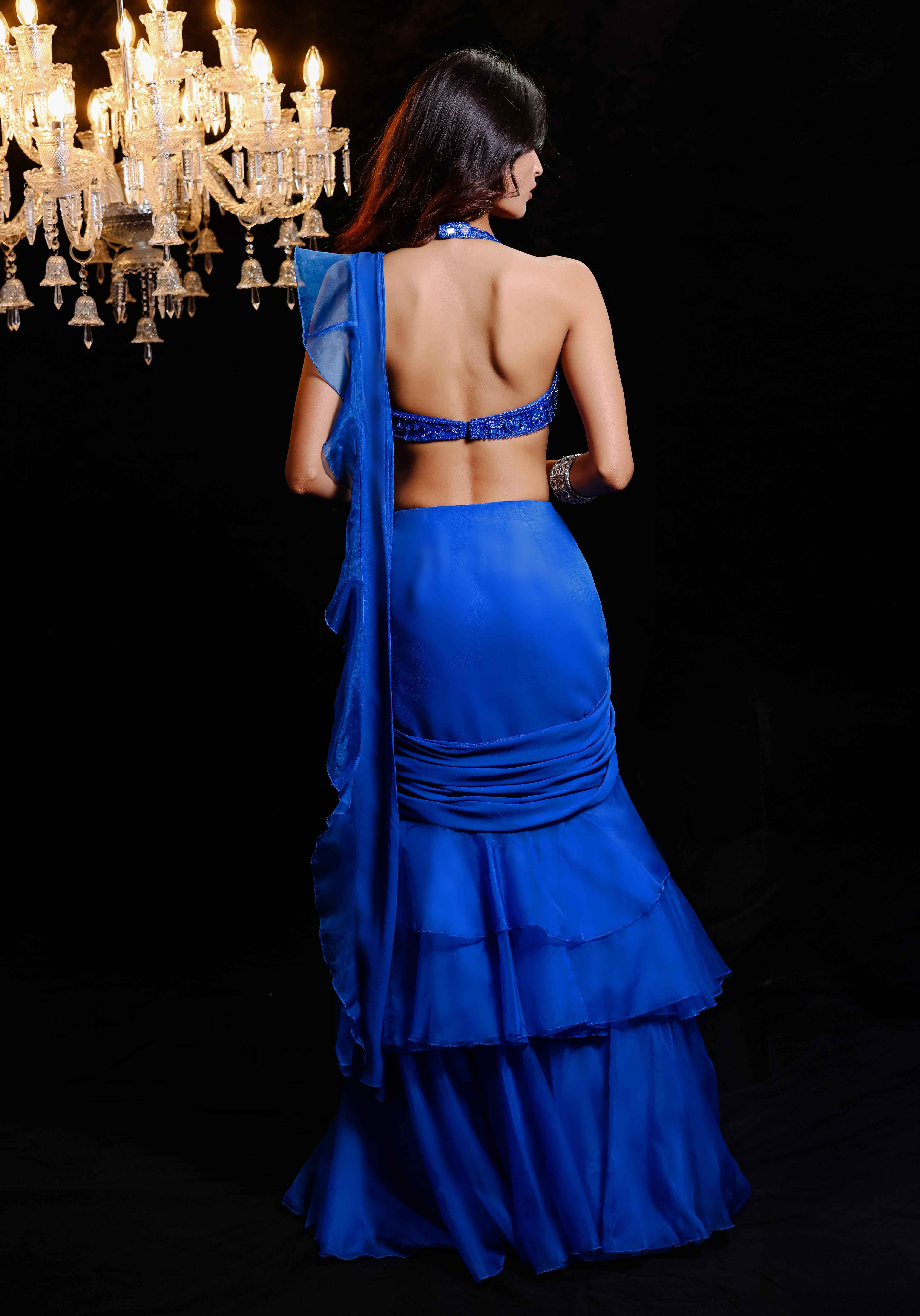 A model showcasing Electric Blue Embroidered Ruffle Predraped Saree Set by Foram Patel from Foram Patel's collection