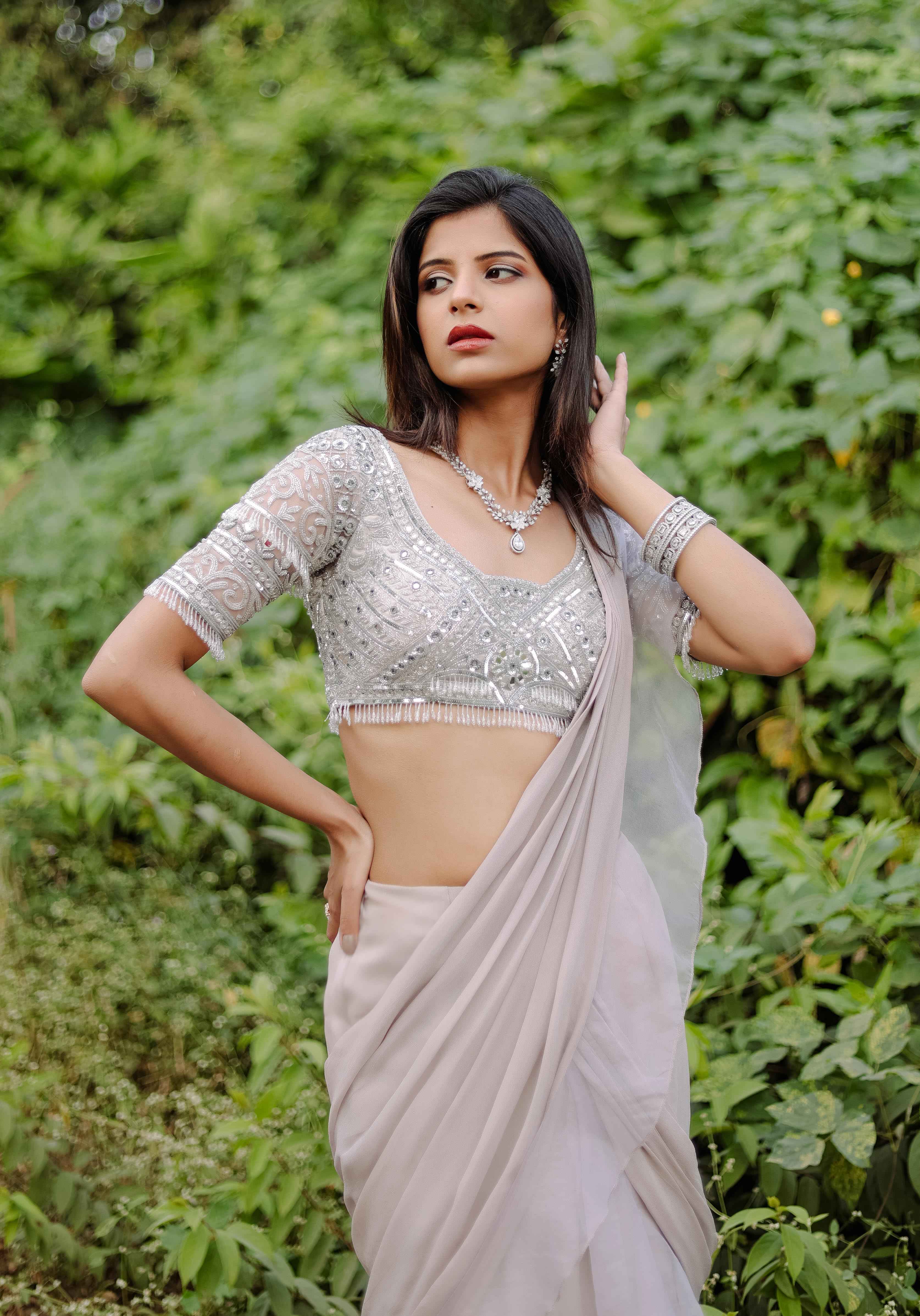 A model showcasing Grey Embroidered Ruffle Predraped Saree Set by Foram Patel from Foram Patel's collection