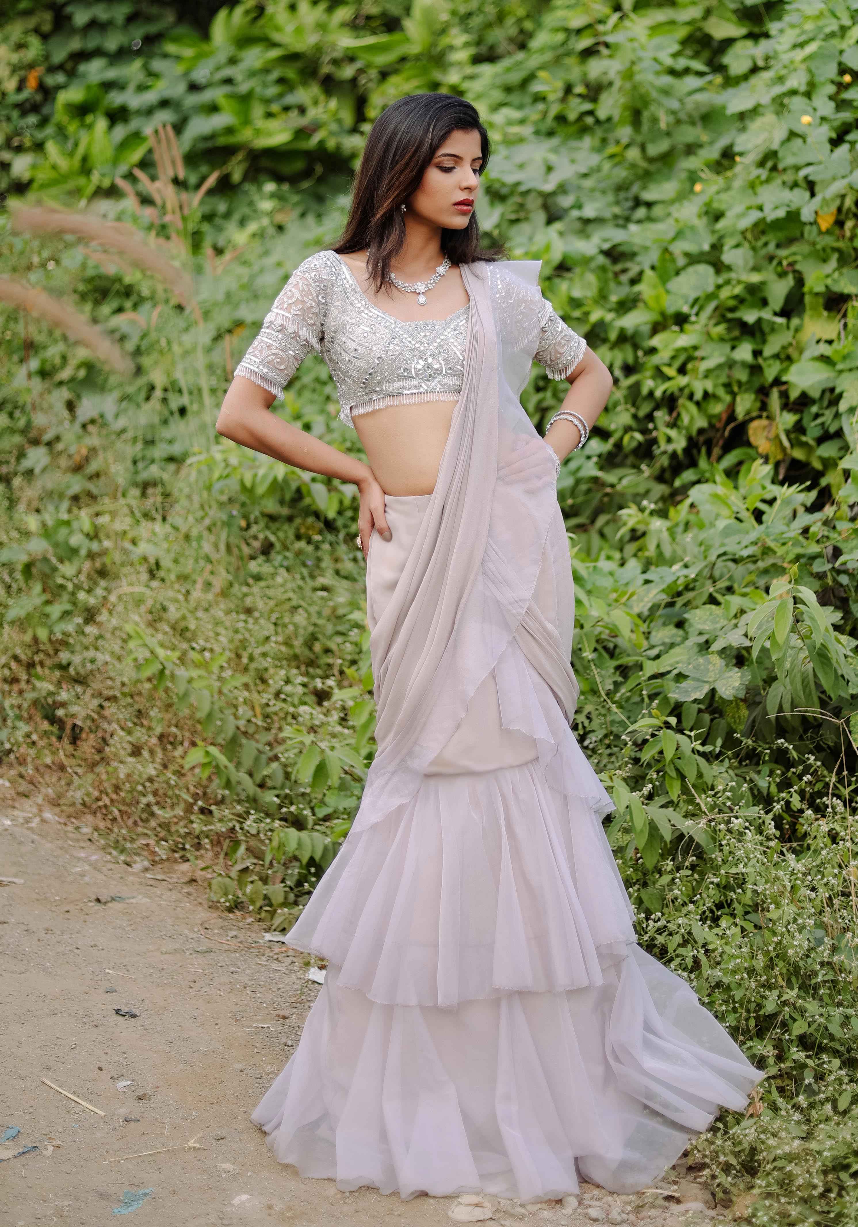 A model showcasing Grey Embroidered Ruffle Predraped Saree Set by Foram Patel from Foram Patel's collection