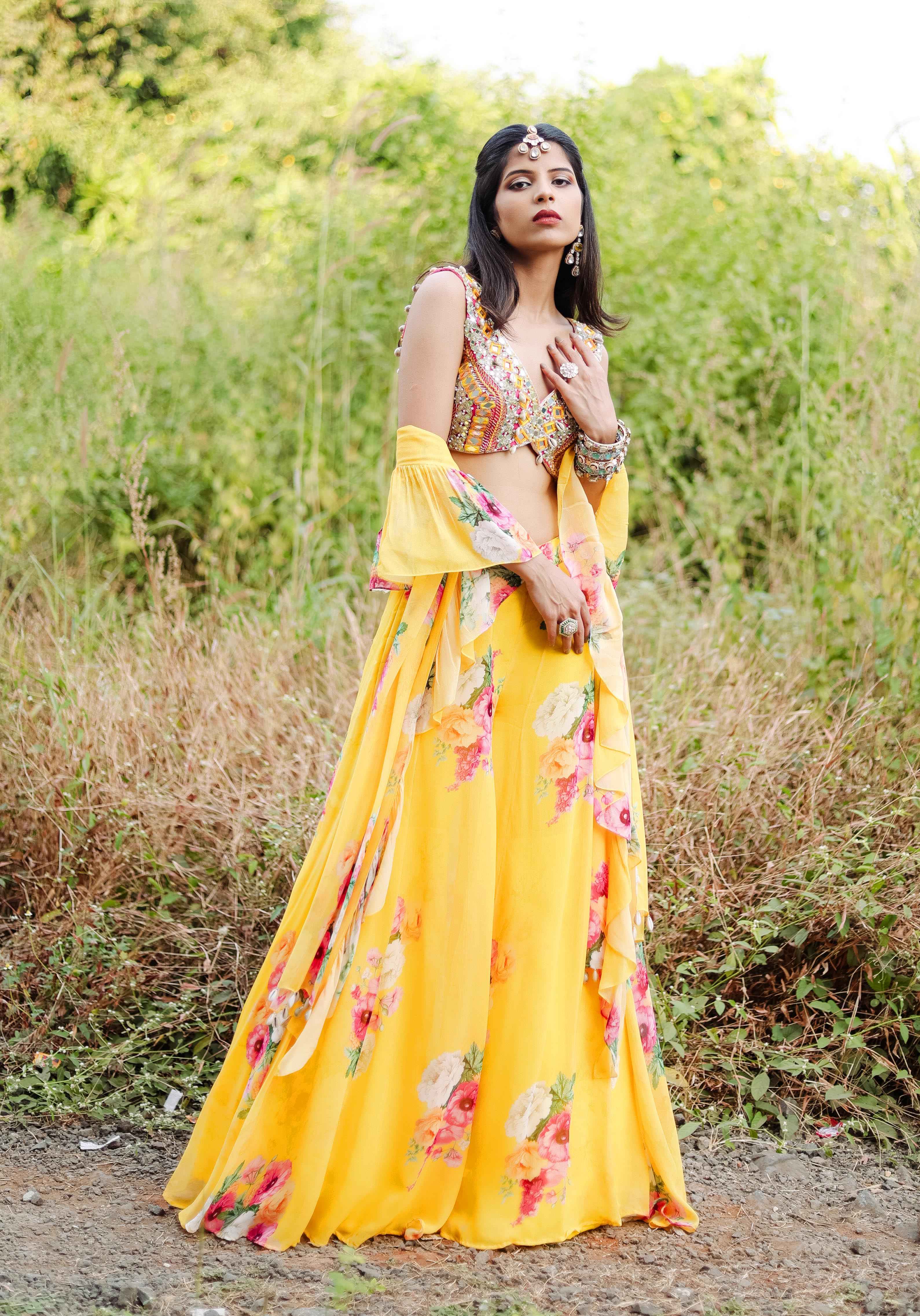A model showcasing Yellow Mirror And Cowrie Embroidered Coord Set by Foram Patel from Foram Patel's collection A model showcasing Yellow Mirror And Cowrie Embroidered Coord Set by Foram Patel from Foram Patel's collection