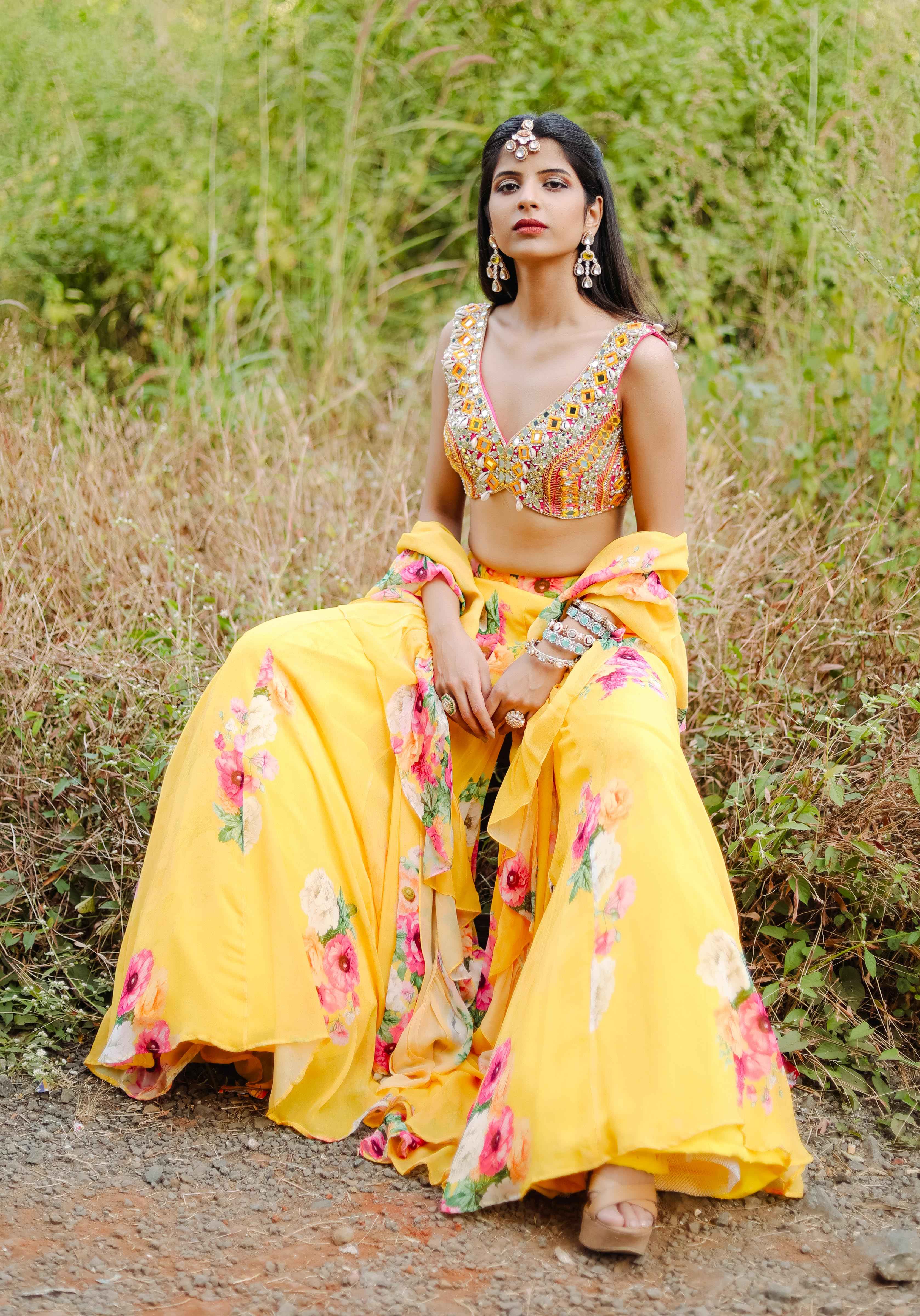 A model showcasing Yellow Mirror And Cowrie Embroidered Coord Set by Foram Patel from Foram Patel's collection A model showcasing Yellow Mirror And Cowrie Embroidered Coord Set by Foram Patel from Foram Patel's collection