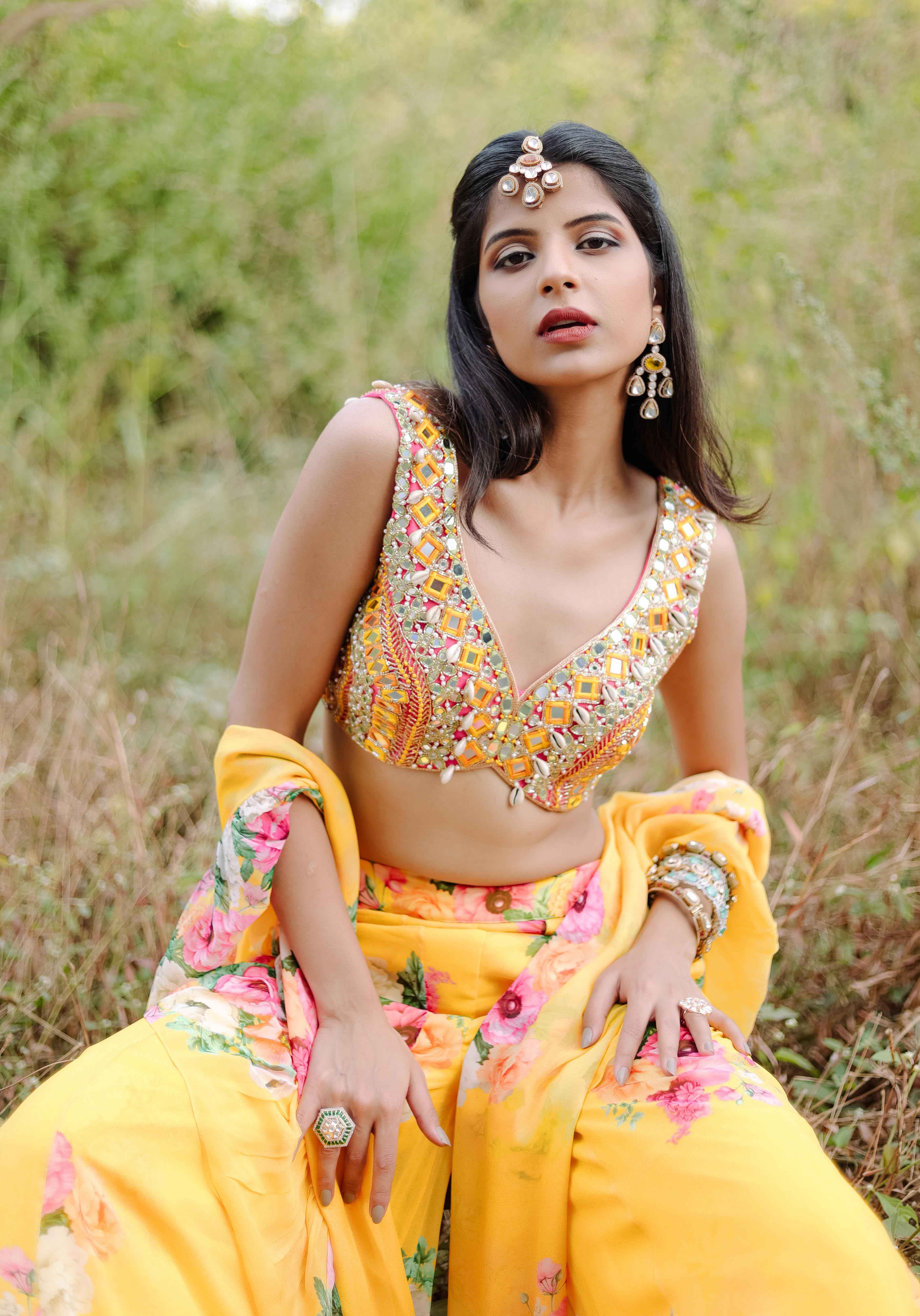 A model showcasing Yellow Mirror And Cowrie Embroidered Coord Set by Foram Patel from Foram Patel's collection A model showcasing Yellow Mirror And Cowrie Embroidered Coord Set by Foram Patel from Foram Patel's collection