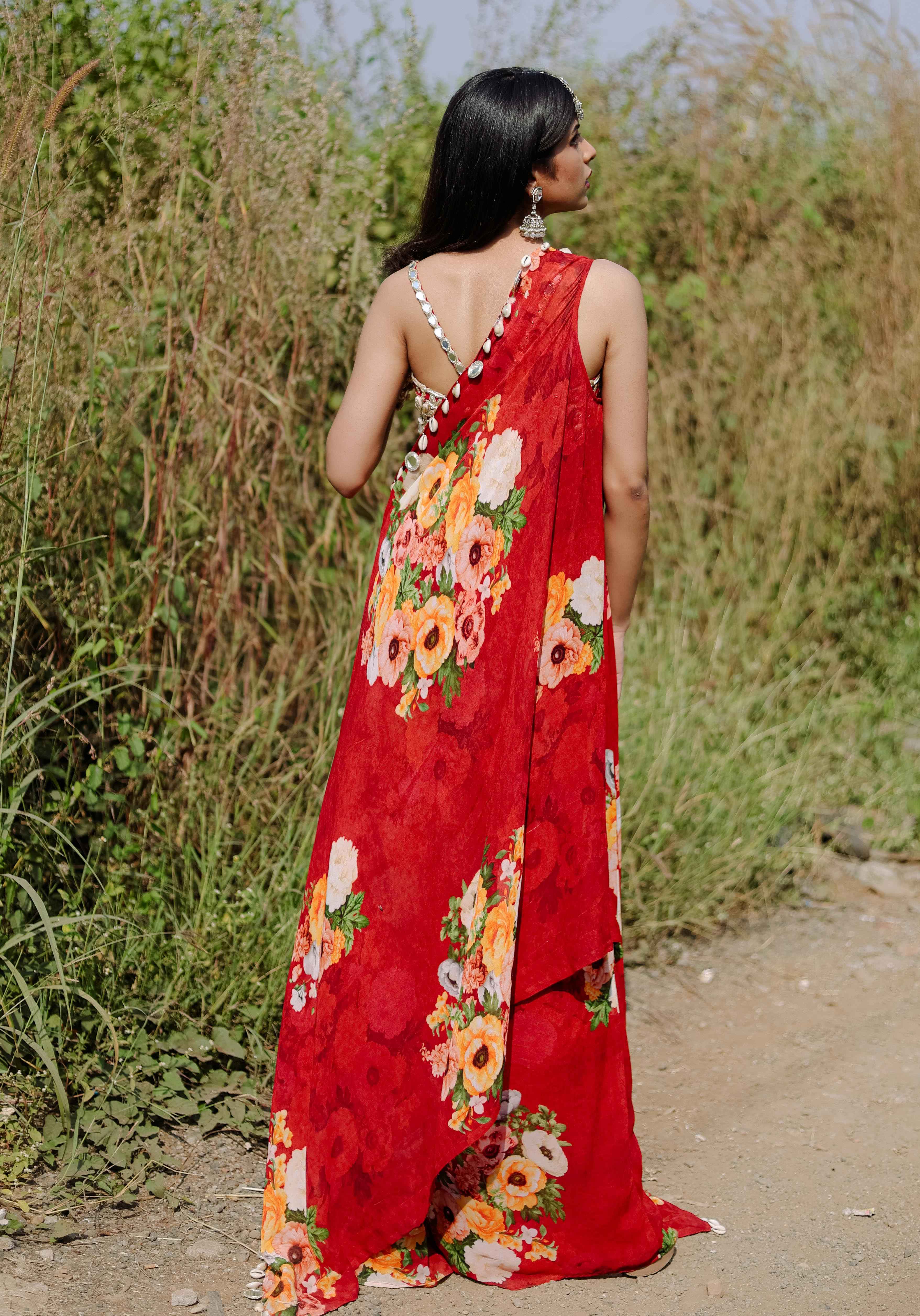 A model showcasing Red Mirror And Cowrie Embroidered Cape Set by Foram Patel from Foram Patel's collection