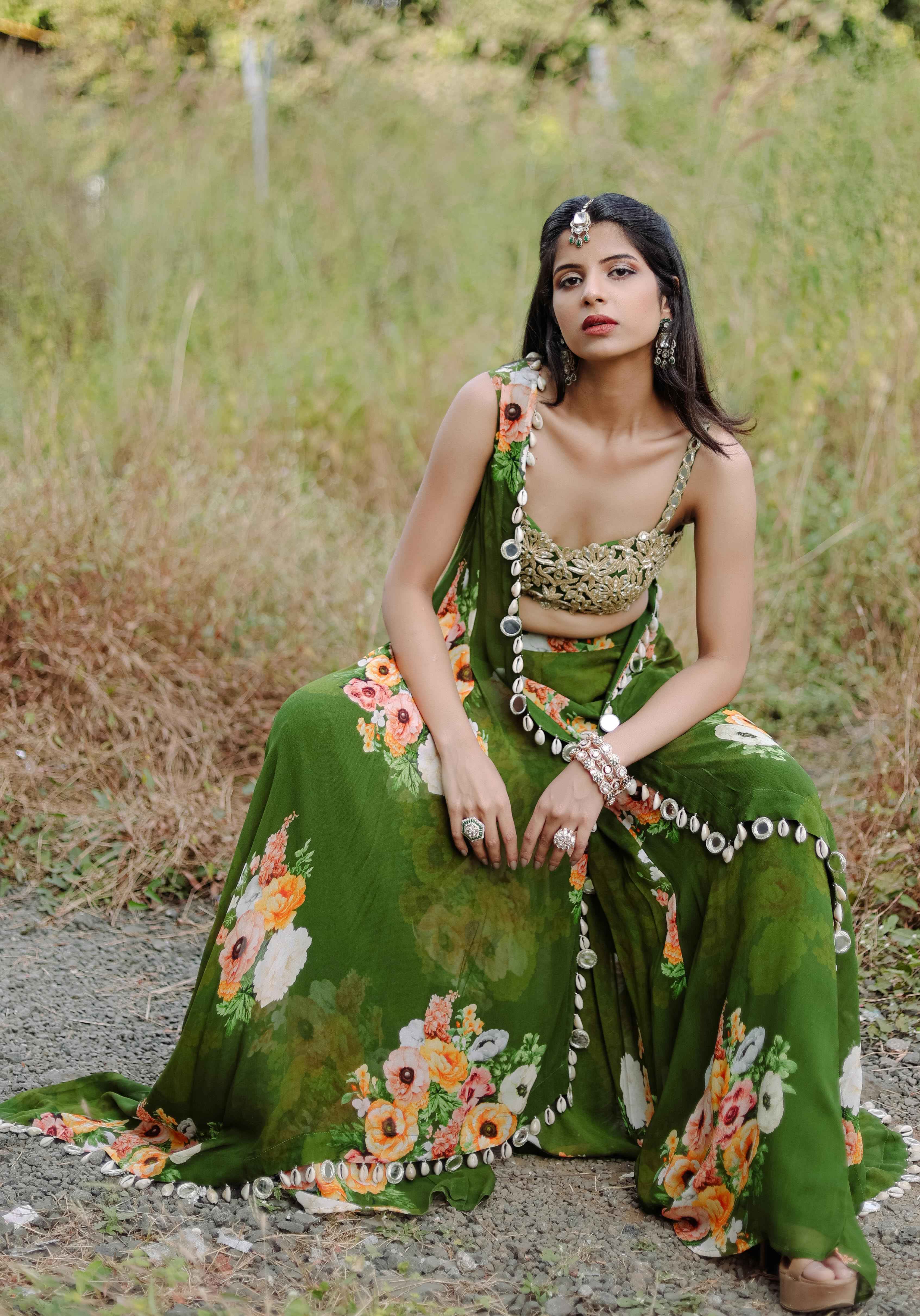 A model showcasing Green Mirror And Cowrie Embroidered Cape Set by Foram Patel from Foram Patel's collection