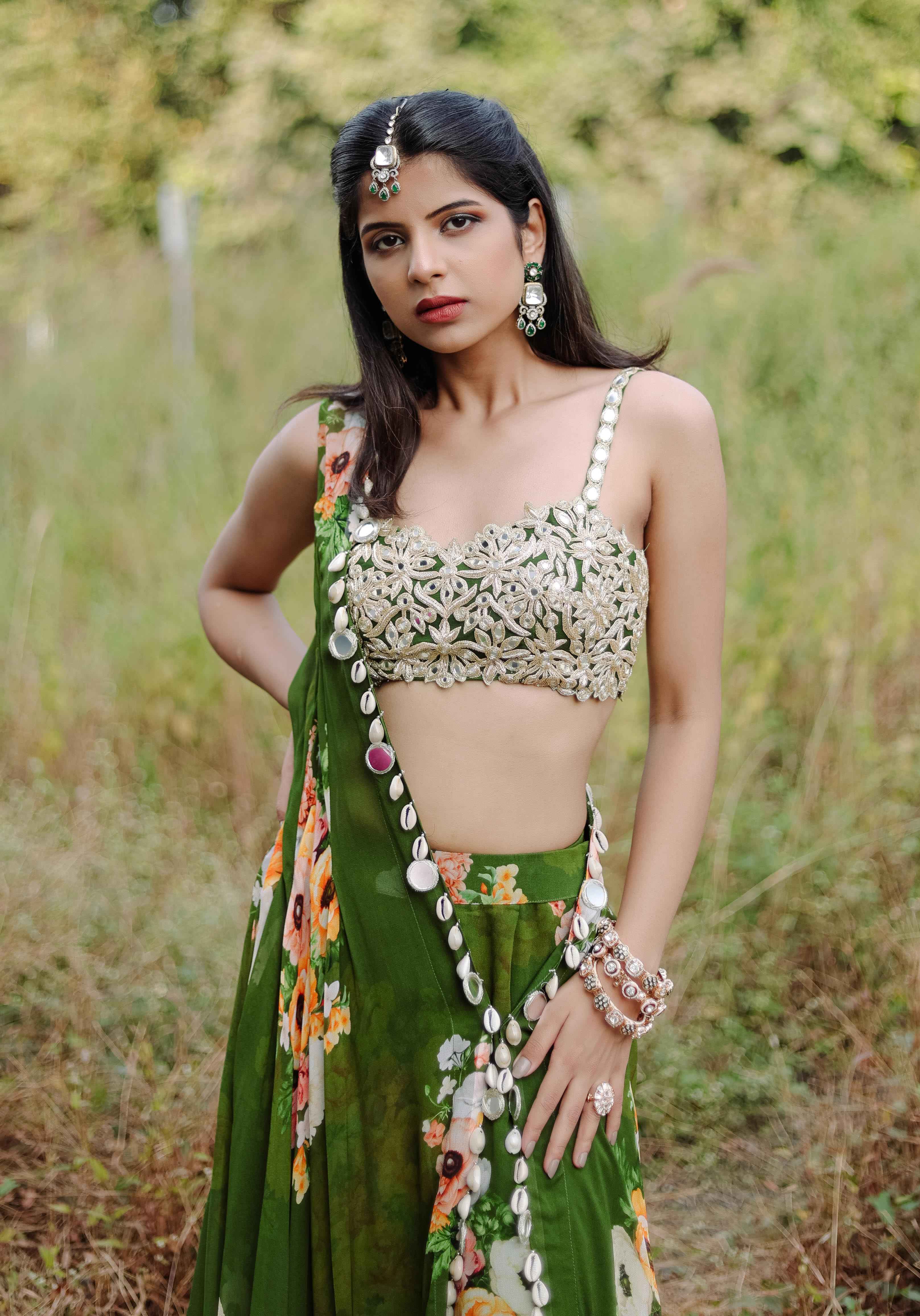 A model showcasing Green Mirror And Cowrie Embroidered Cape Set by Foram Patel from Foram Patel's collection