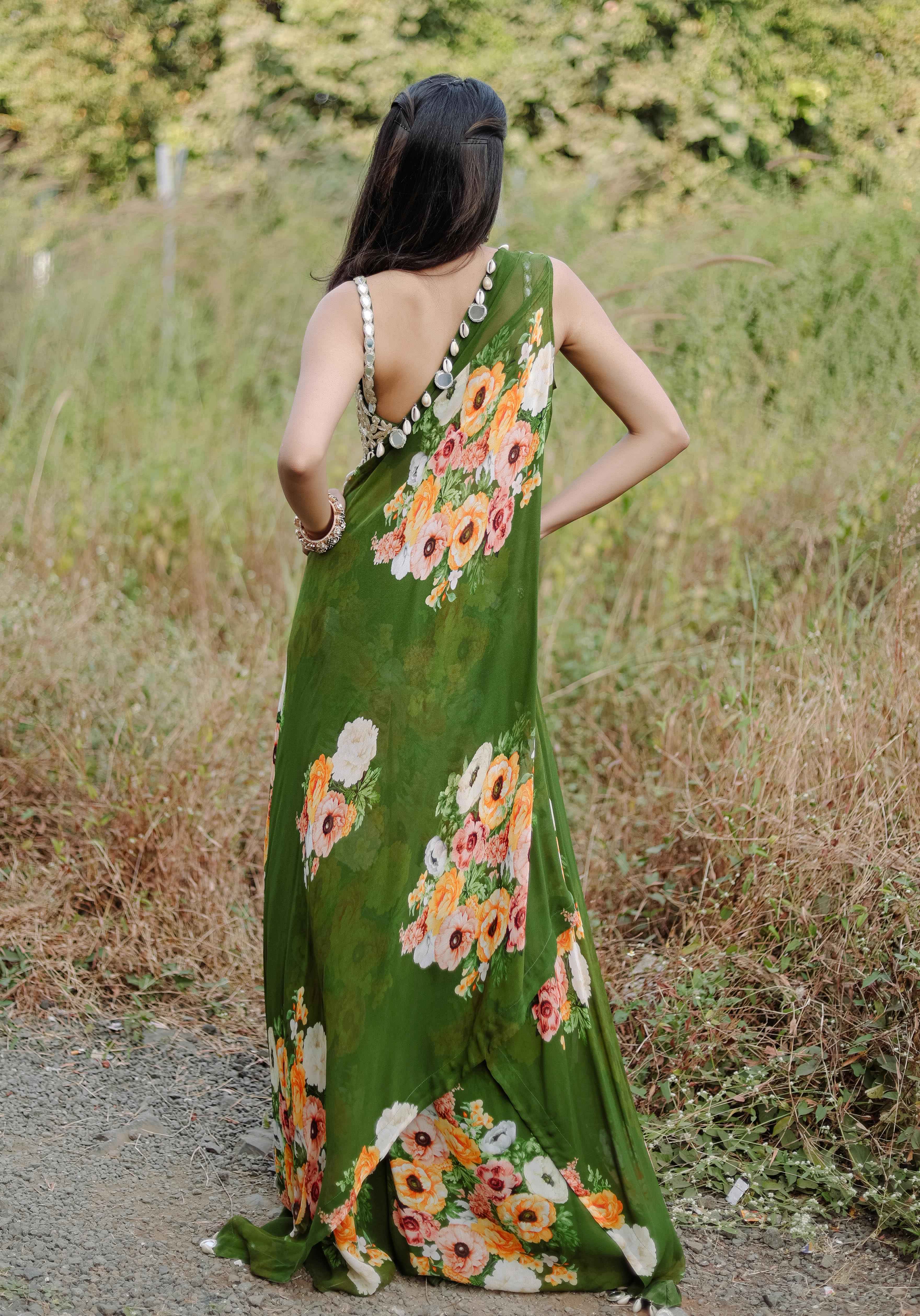 A model showcasing Green Mirror And Cowrie Embroidered Cape Set by Foram Patel from Foram Patel's collection