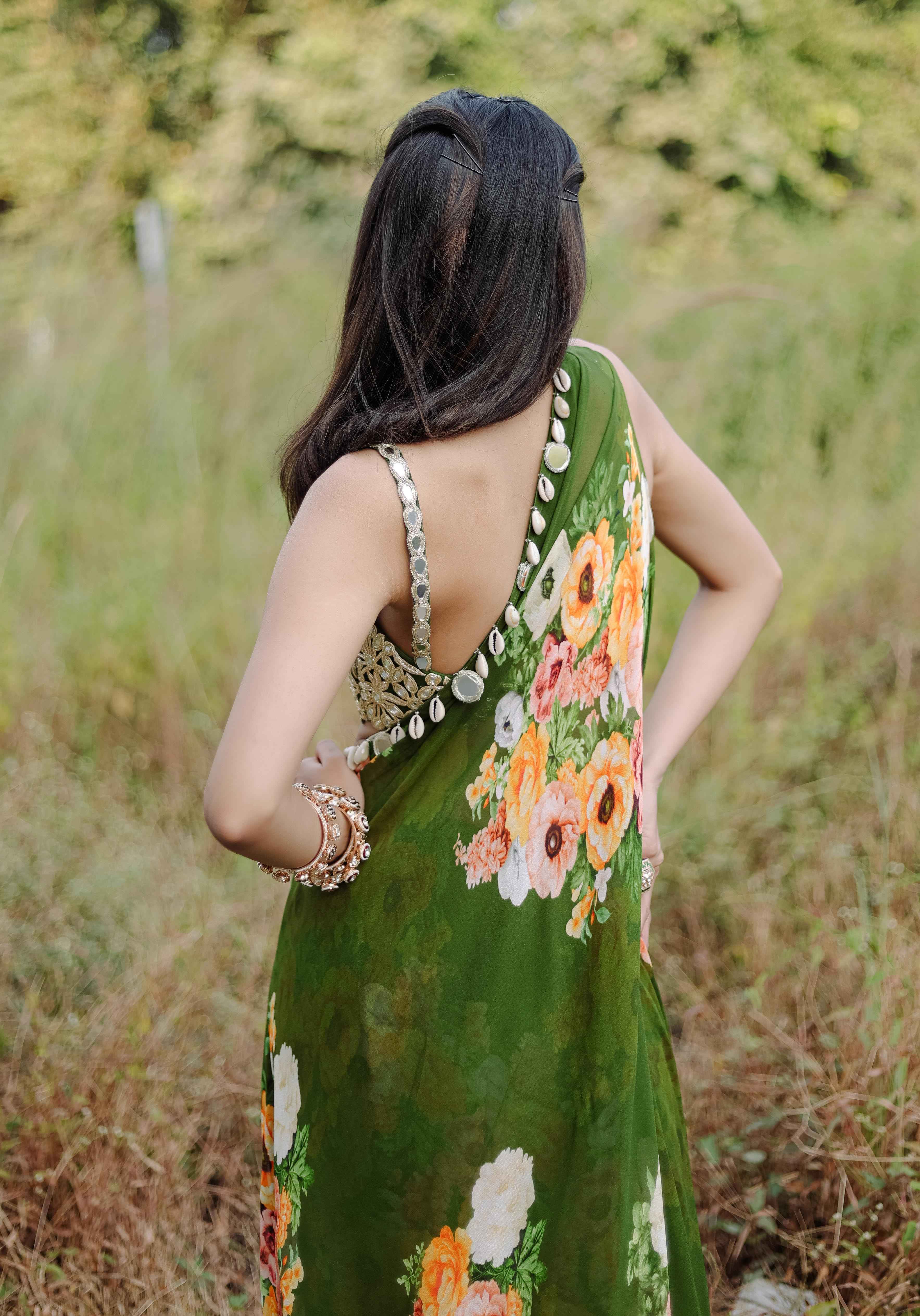 A model showcasing Green Mirror And Cowrie Embroidered Cape Set by Foram Patel from Foram Patel's collection