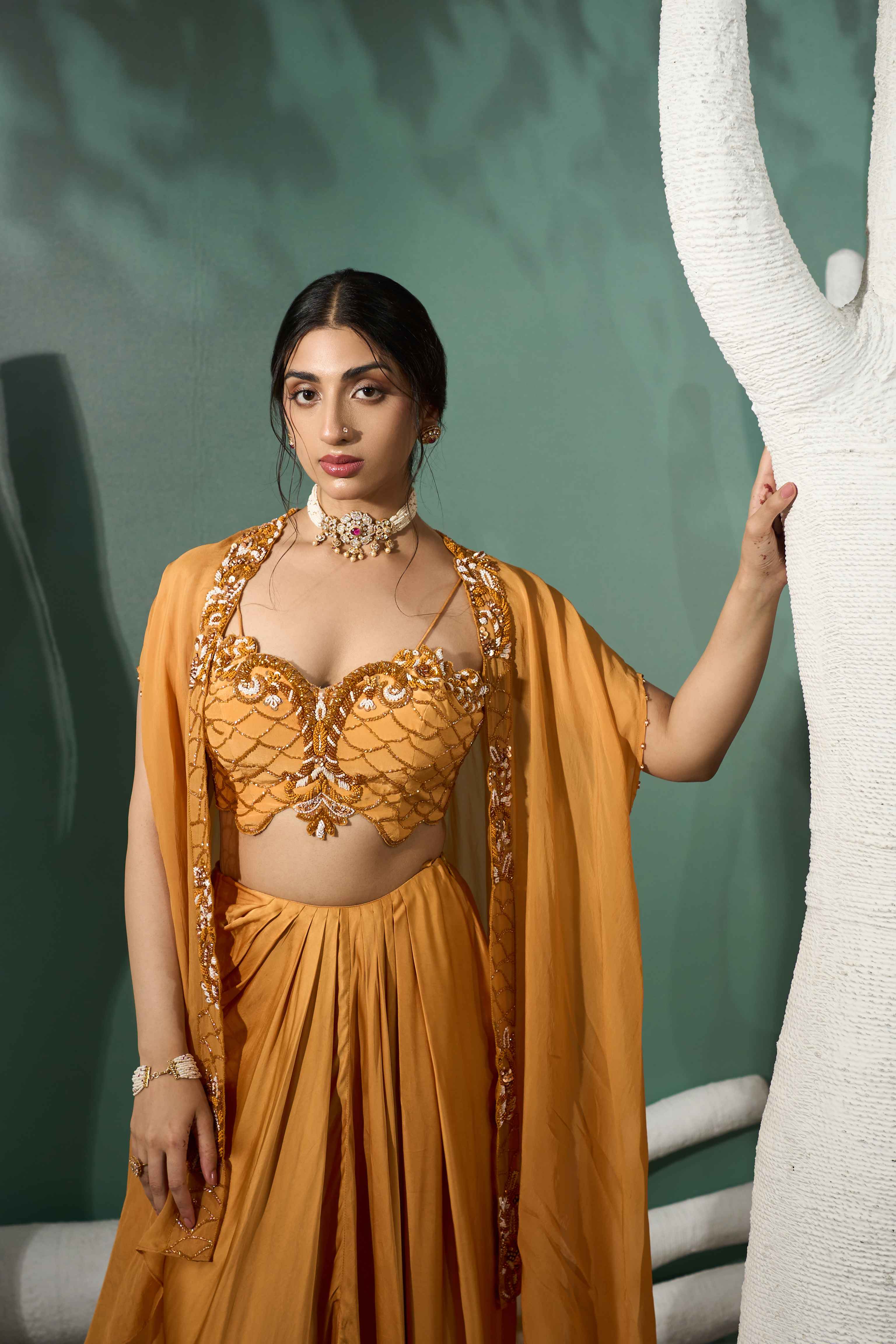 A model showcasing Marigold Yellow Cutwork Cape Set by One Knot One from One Knot One's collection