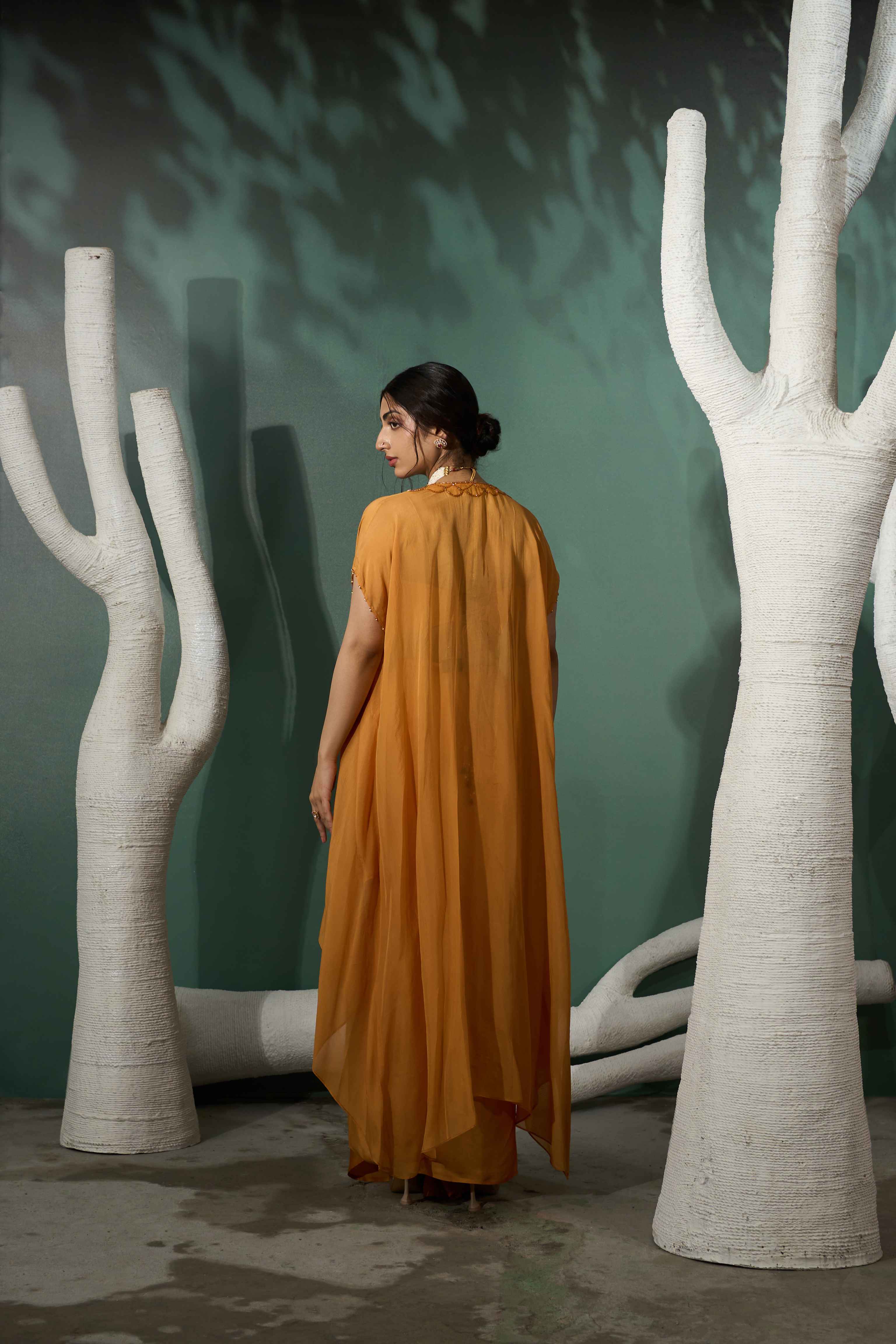 A model showcasing Marigold Yellow Cutwork Cape Set by One Knot One from One Knot One's collection