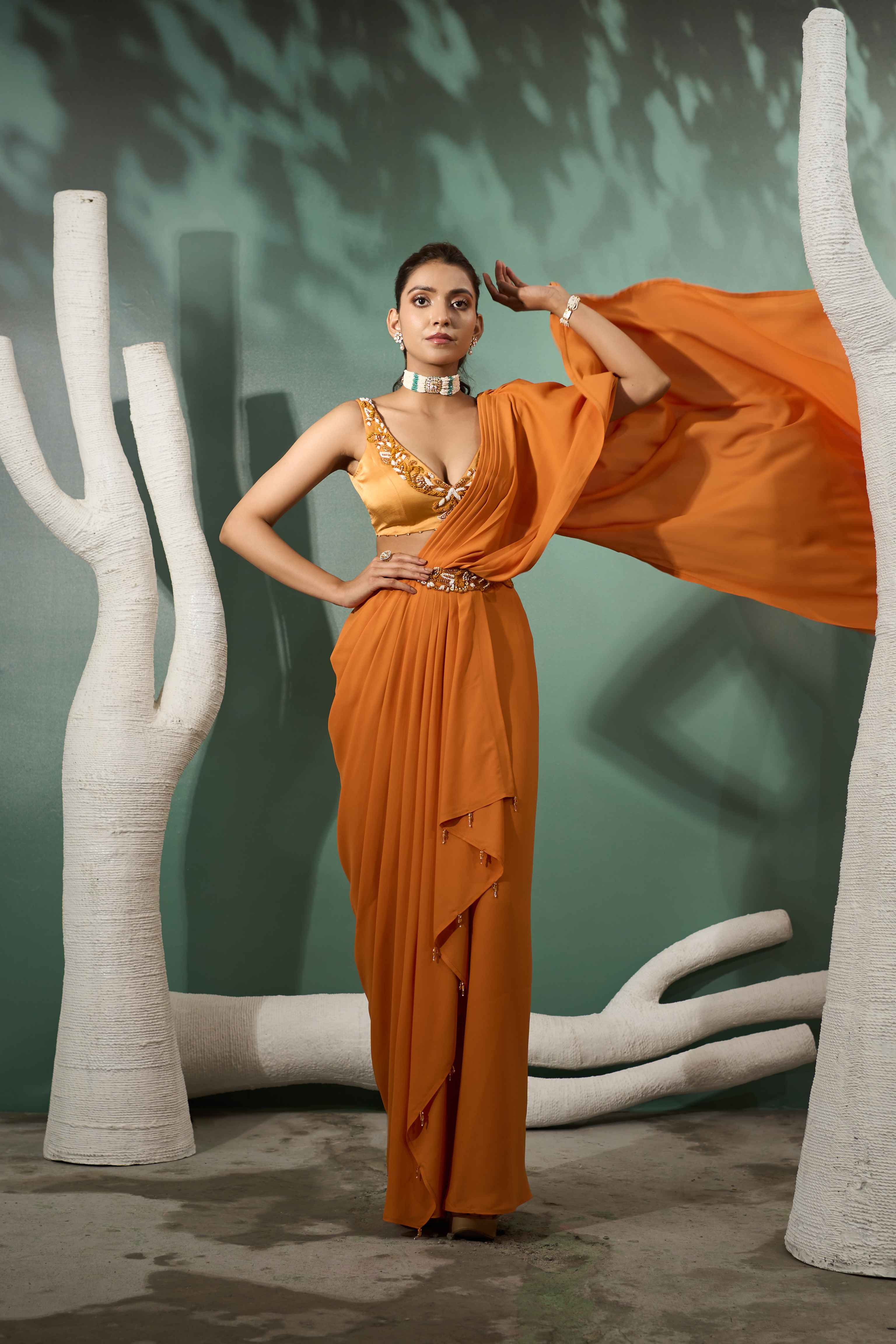 A model showcasing Marigold Yellow Pre Stitched Drape Saree by One Knot One from One Knot One's collection