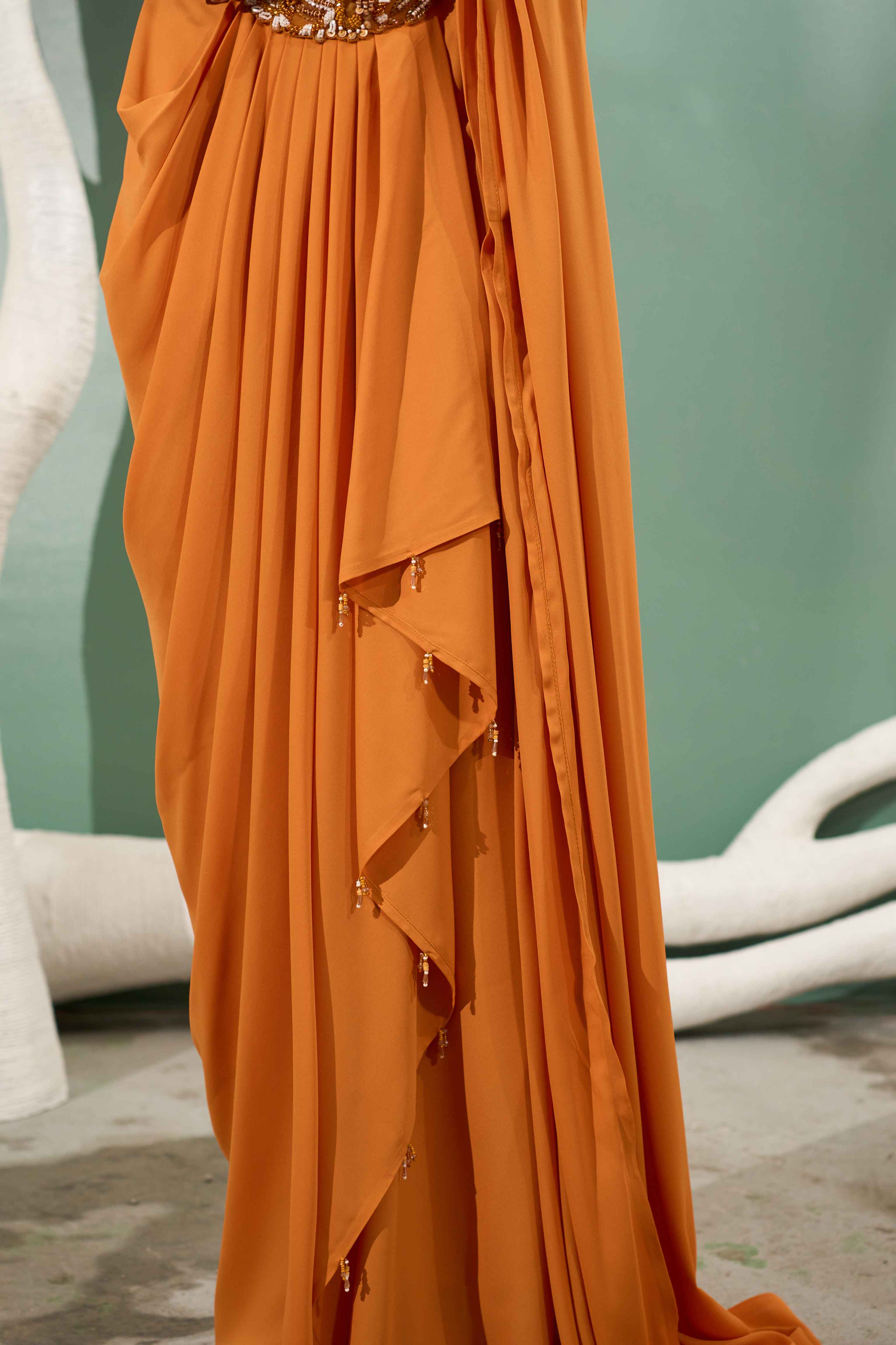 A model showcasing Marigold Yellow Pre Stitched Drape Saree by One Knot One from One Knot One's collection