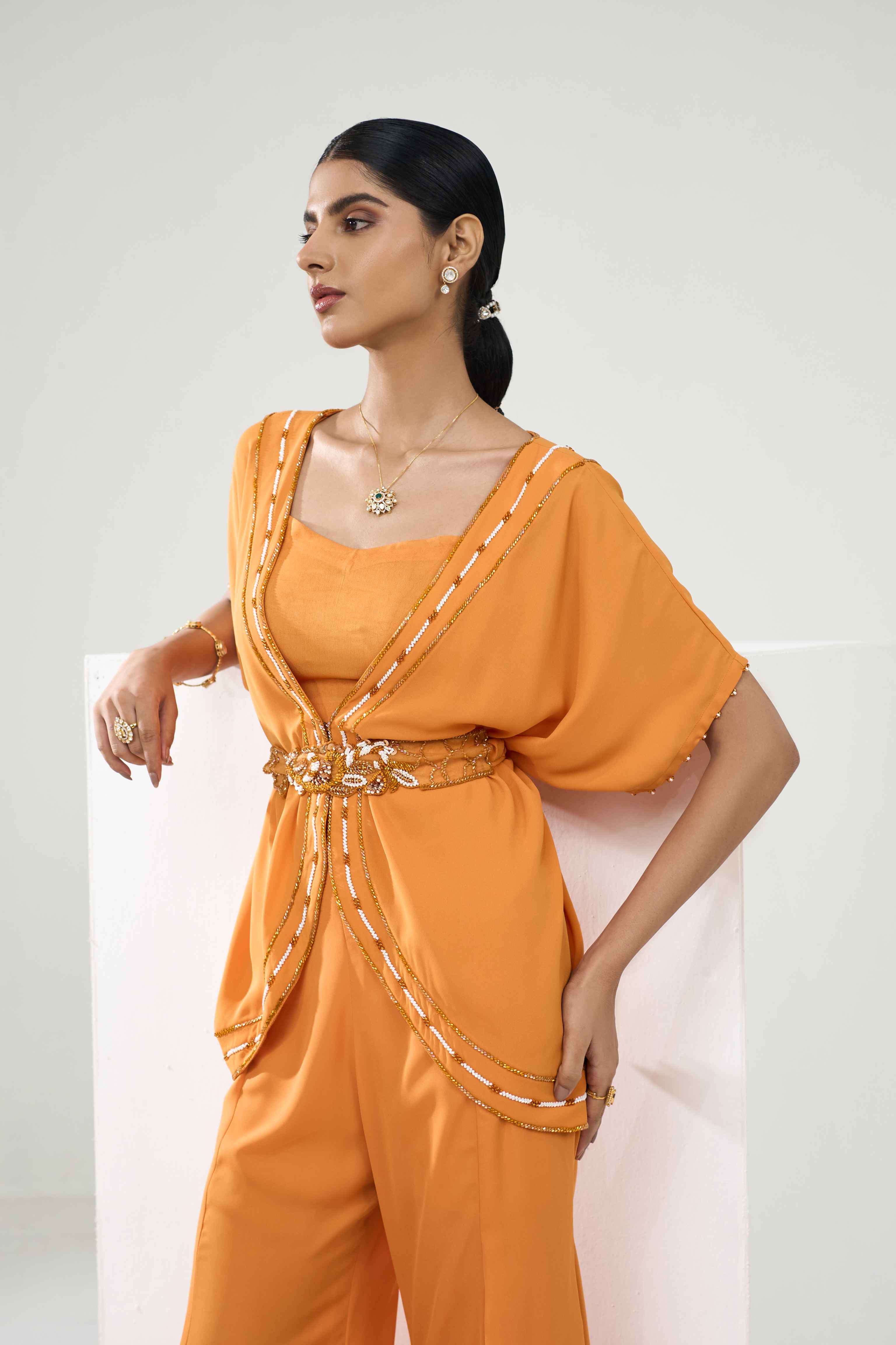 A model showcasing Marigold Embroidered Coord Set With Flared Pants by One Knot One from One Knot One's collection