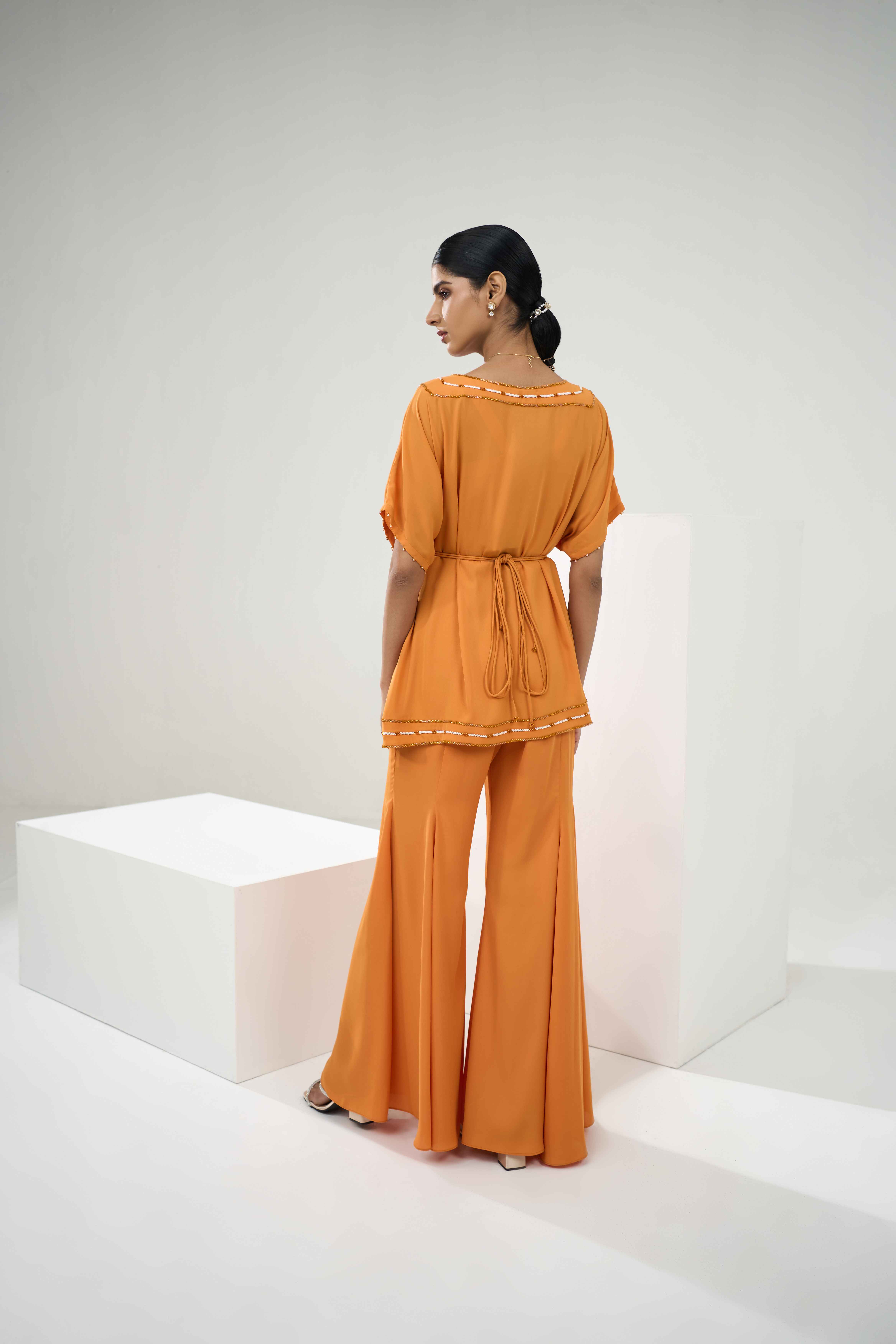 A model showcasing Marigold Embroidered Coord Set With Flared Pants by One Knot One from One Knot One's collection