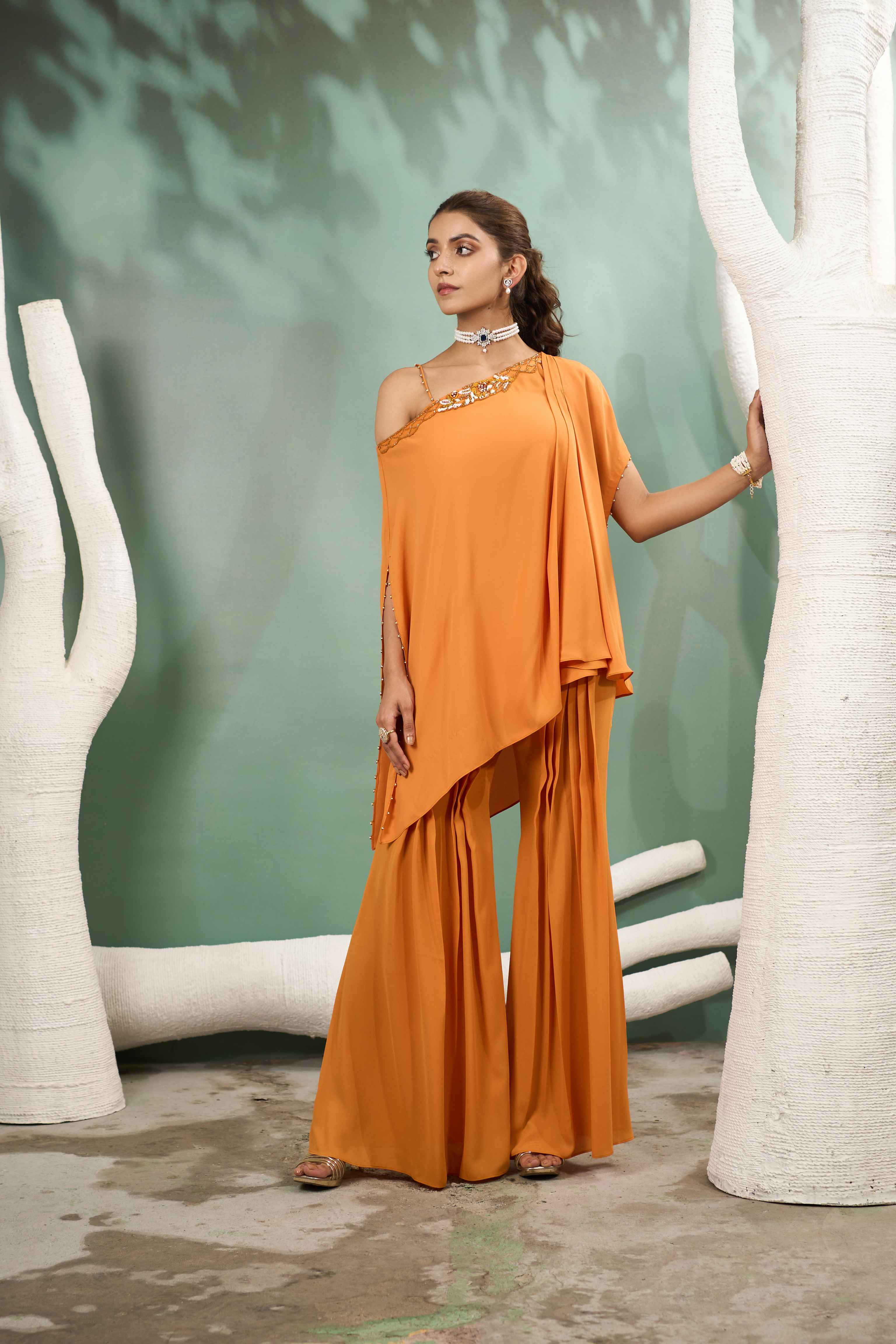 A model showcasing Hand Embroidered Yellow Georgette Coord Set by One Knot One from One Knot One's collection