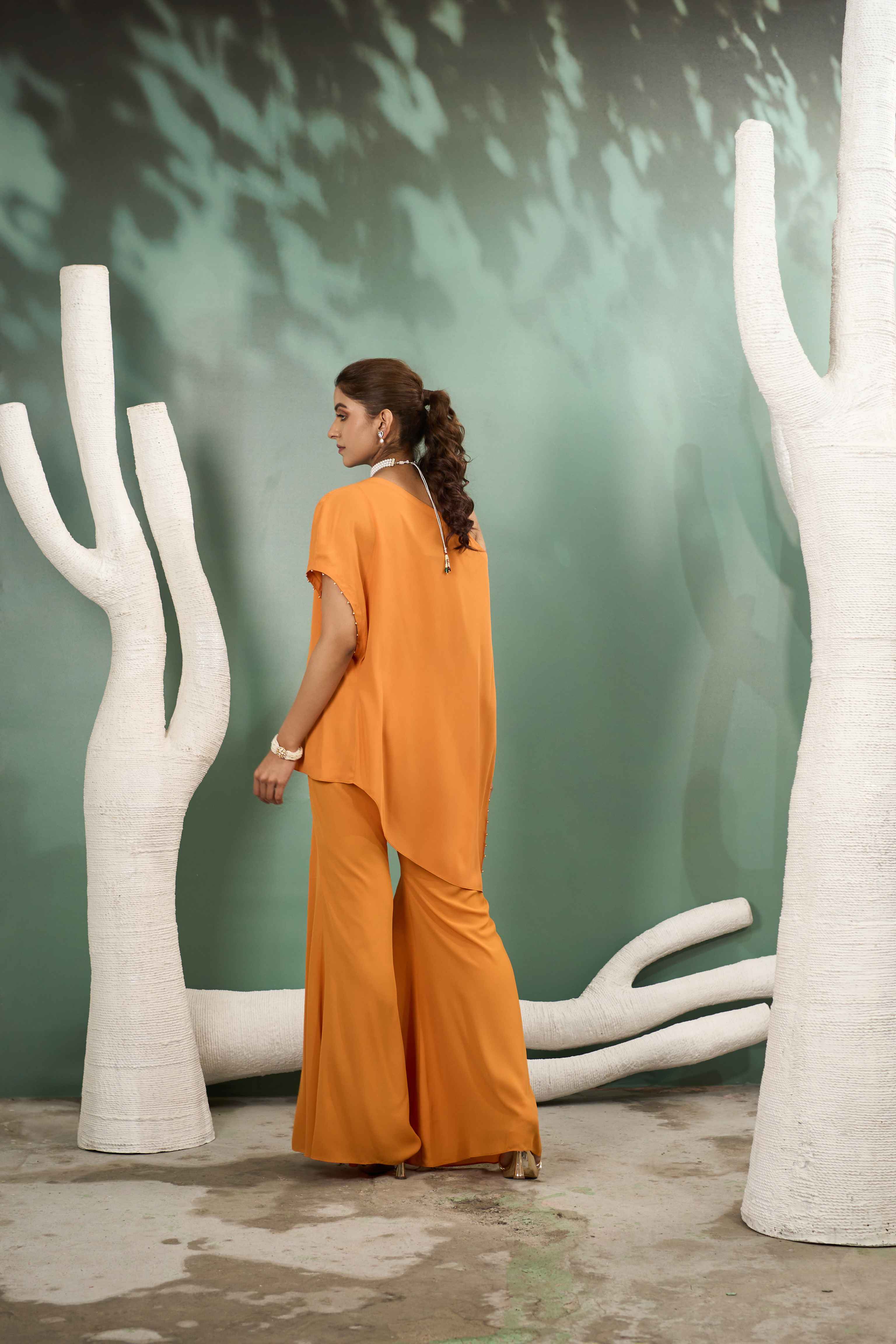 A model showcasing Hand Embroidered Yellow Georgette Coord Set by One Knot One from One Knot One's collection