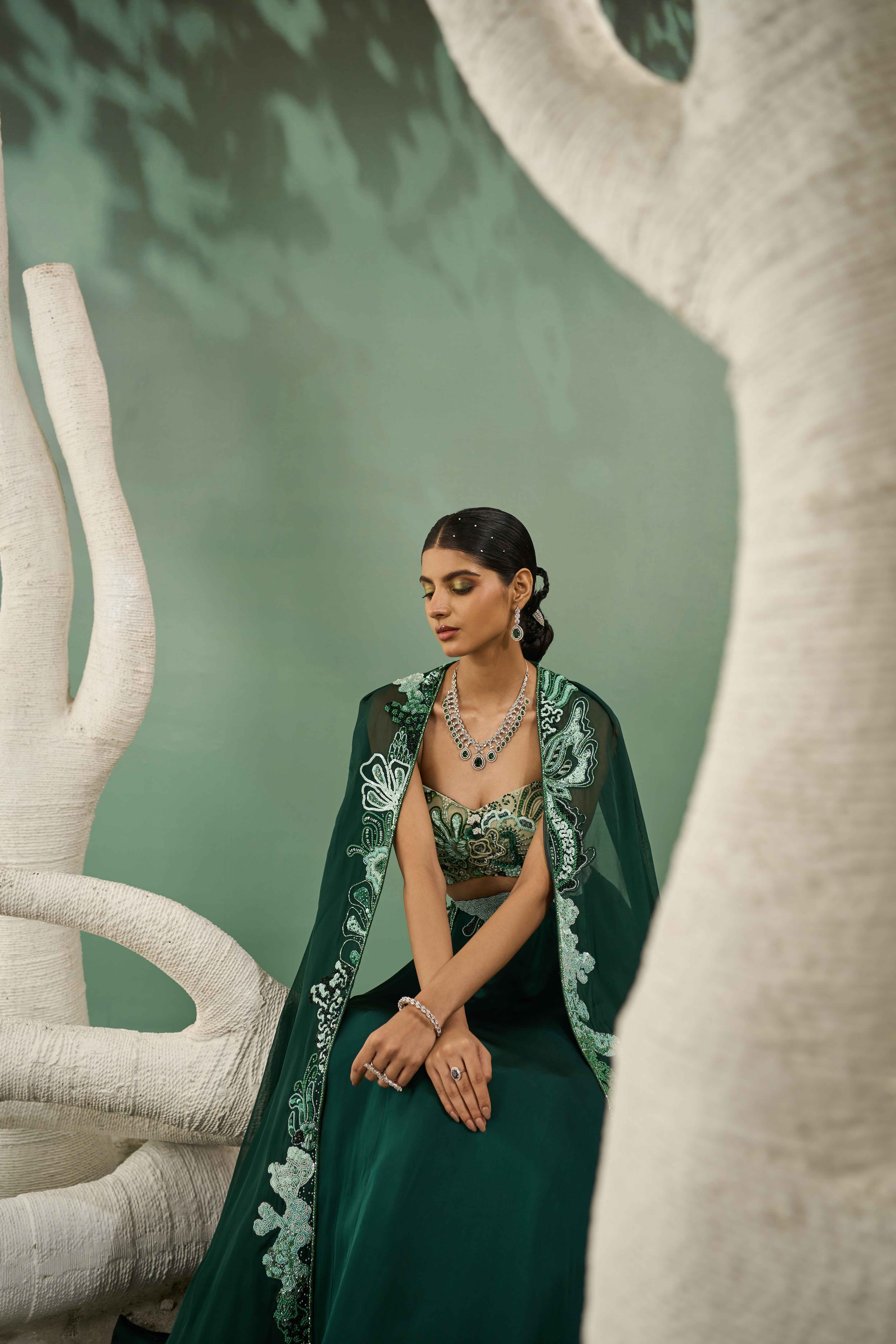 A model showcasing Mint Dark Green Applique Lehenga With Cutout Jacket by One Knot One from One Knot One's collection
