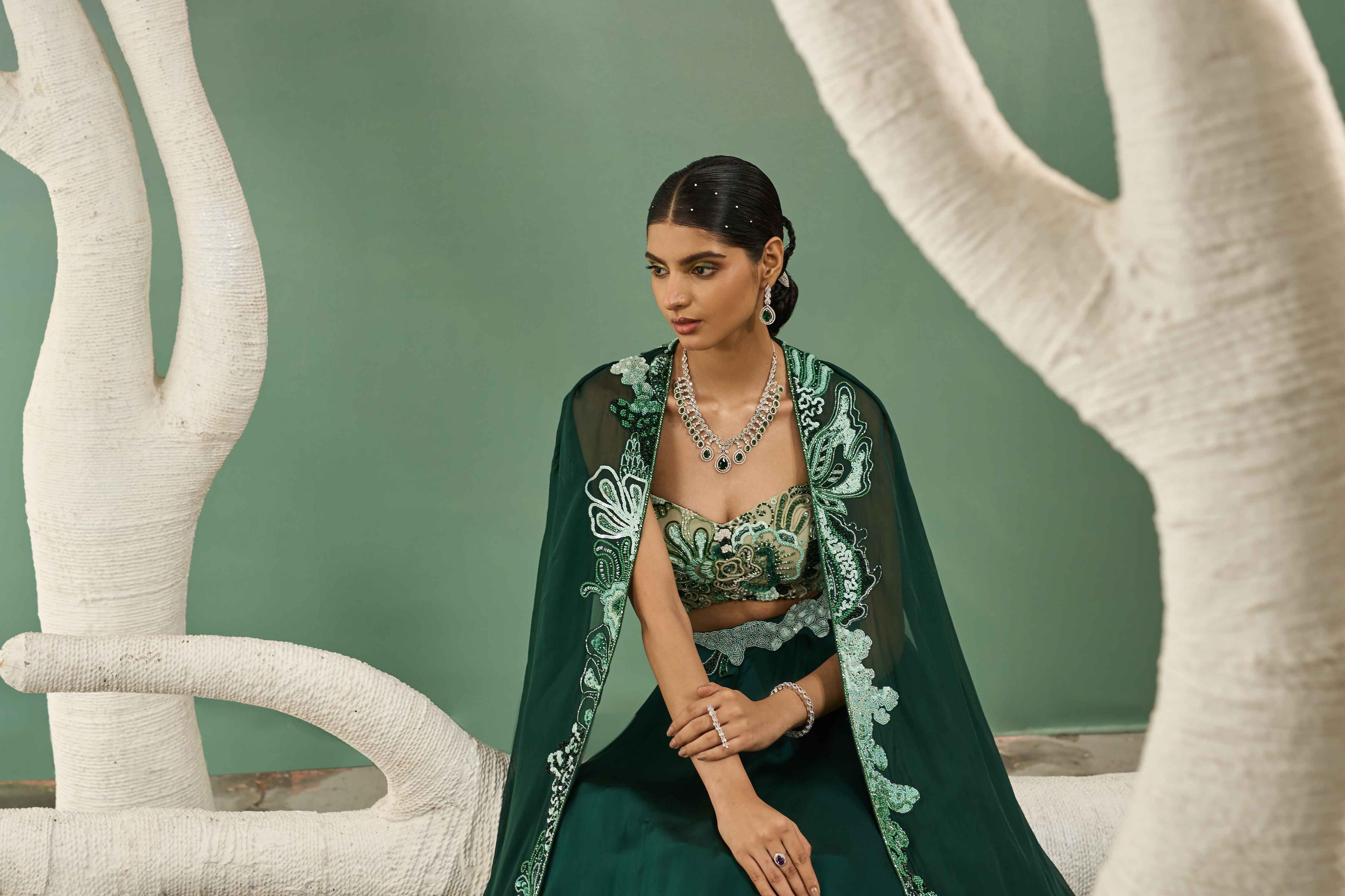 A model showcasing Mint Dark Green Applique Lehenga With Cutout Jacket by One Knot One from One Knot One's collection