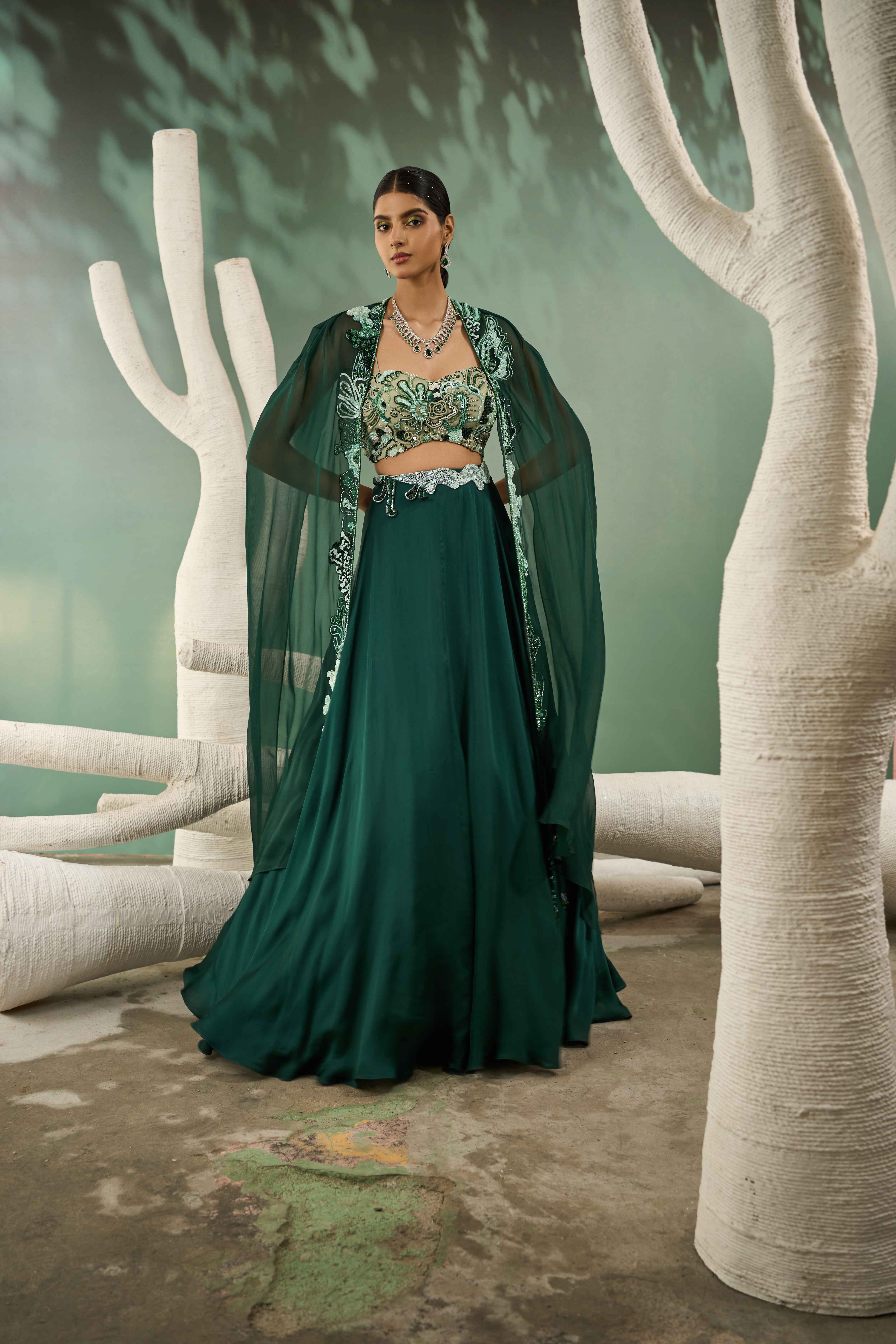 A model showcasing Mint Dark Green Applique Lehenga With Cutout Jacket by One Knot One from One Knot One's collection