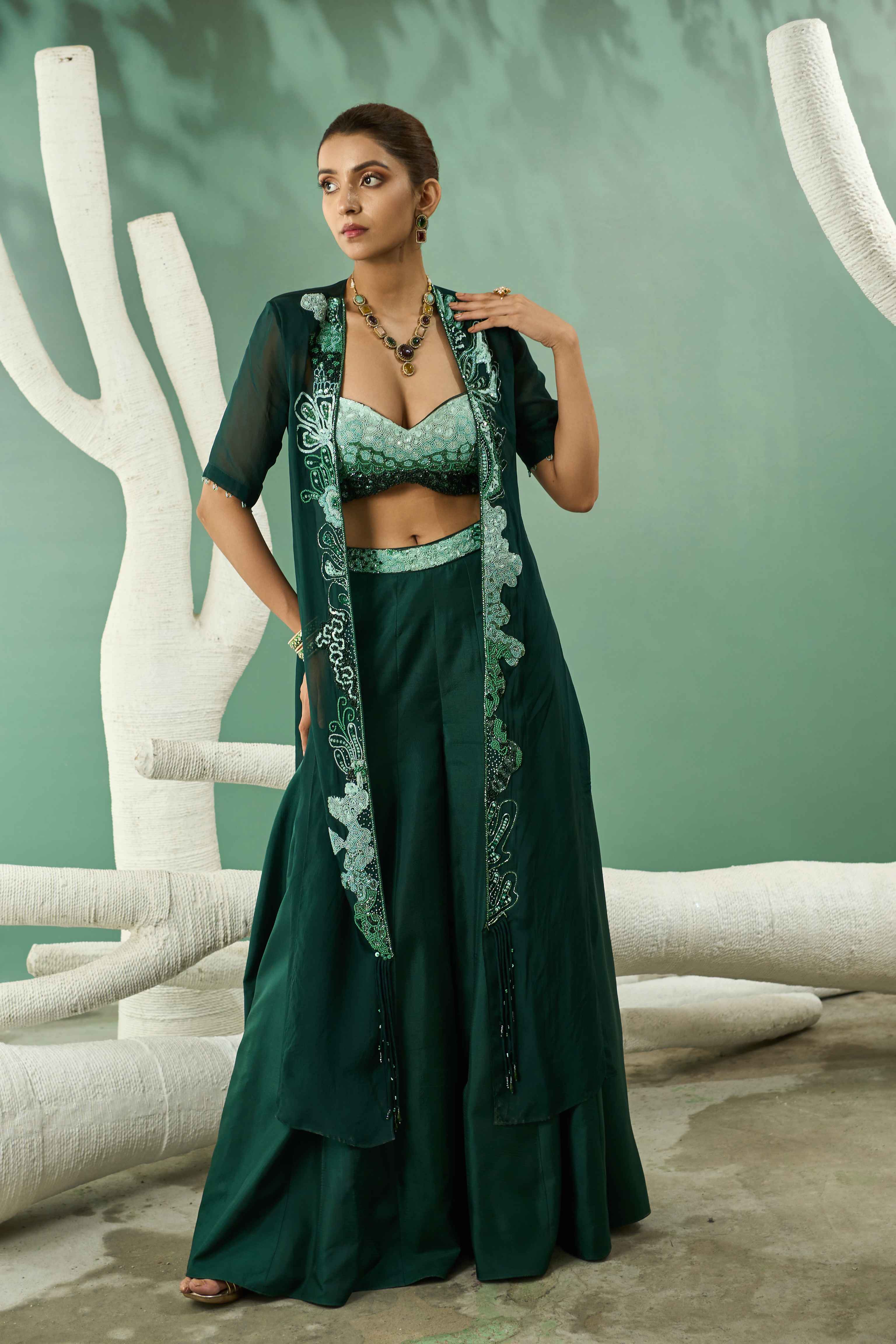 A model showcasing Sharara Set With Ombre Hand Embroidered Blouse And Jacket by One Knot One from One Knot One's collection