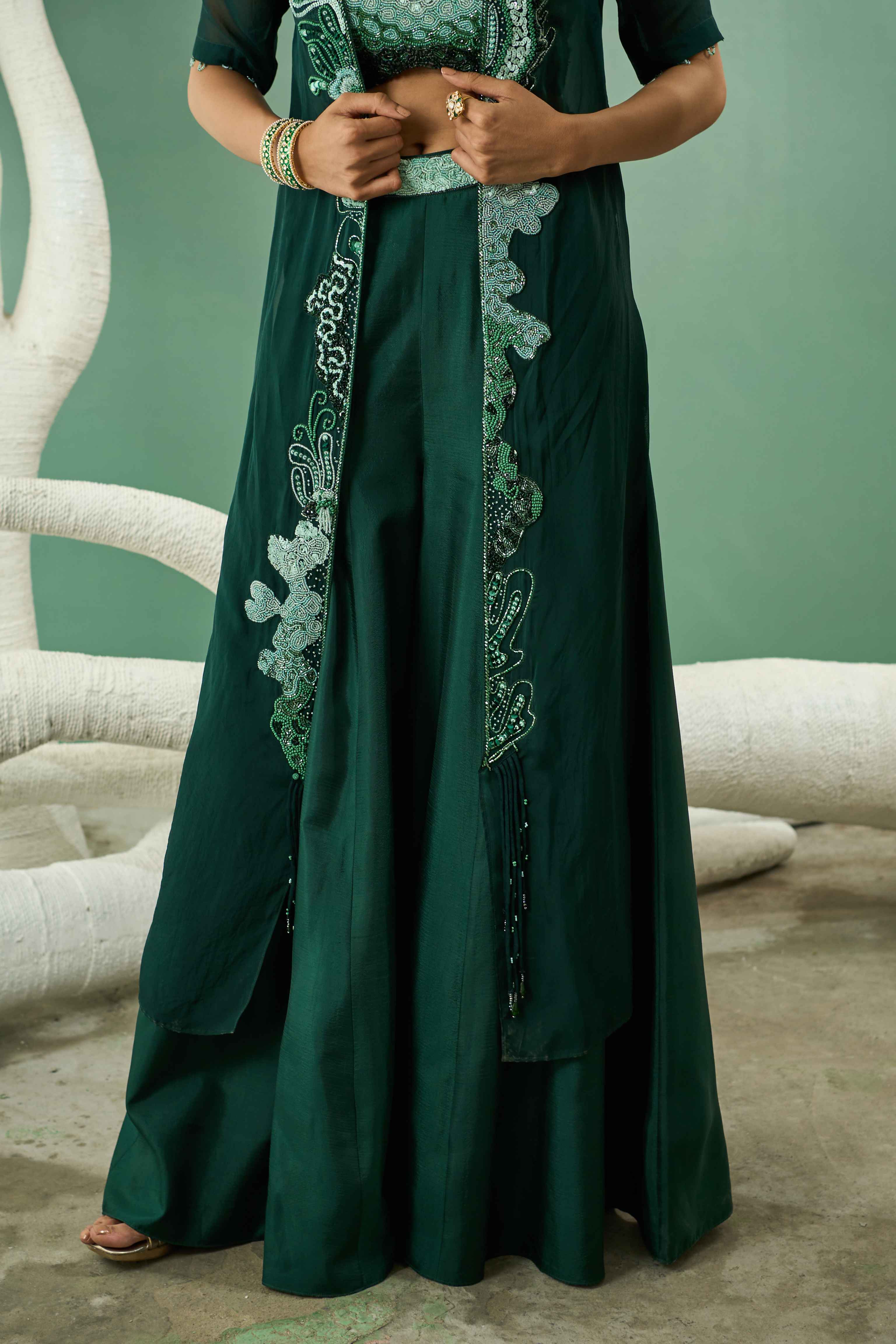 A model showcasing Sharara Set With Ombre Hand Embroidered Blouse And Jacket by One Knot One from One Knot One's collection