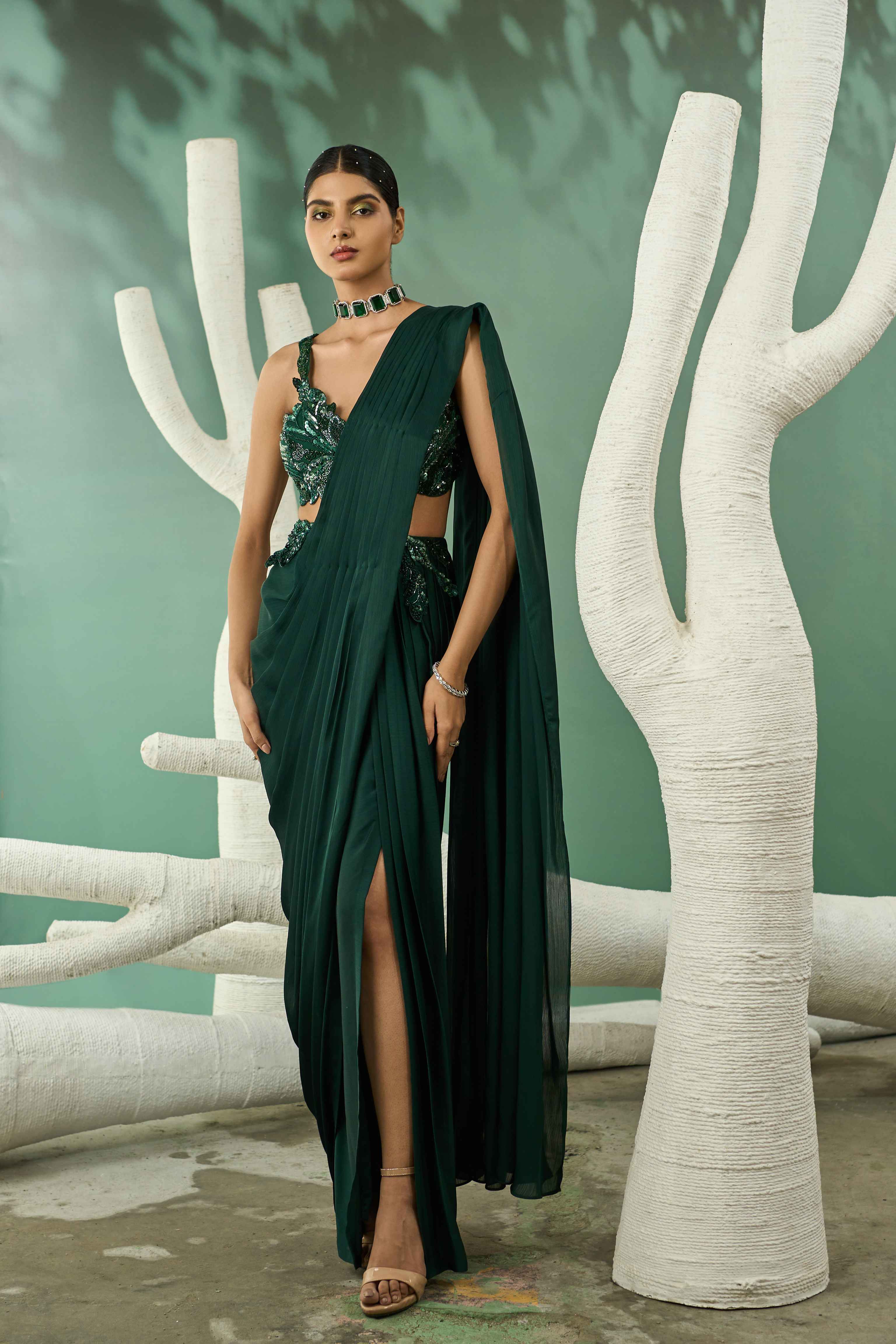 A model showcasing Emerald Green Cutwork Drape Saree Set by One Knot One from One Knot One's collection A model showcasing Emerald Green Cutwork Drape Saree Set by One Knot One from One Knot One's collection
