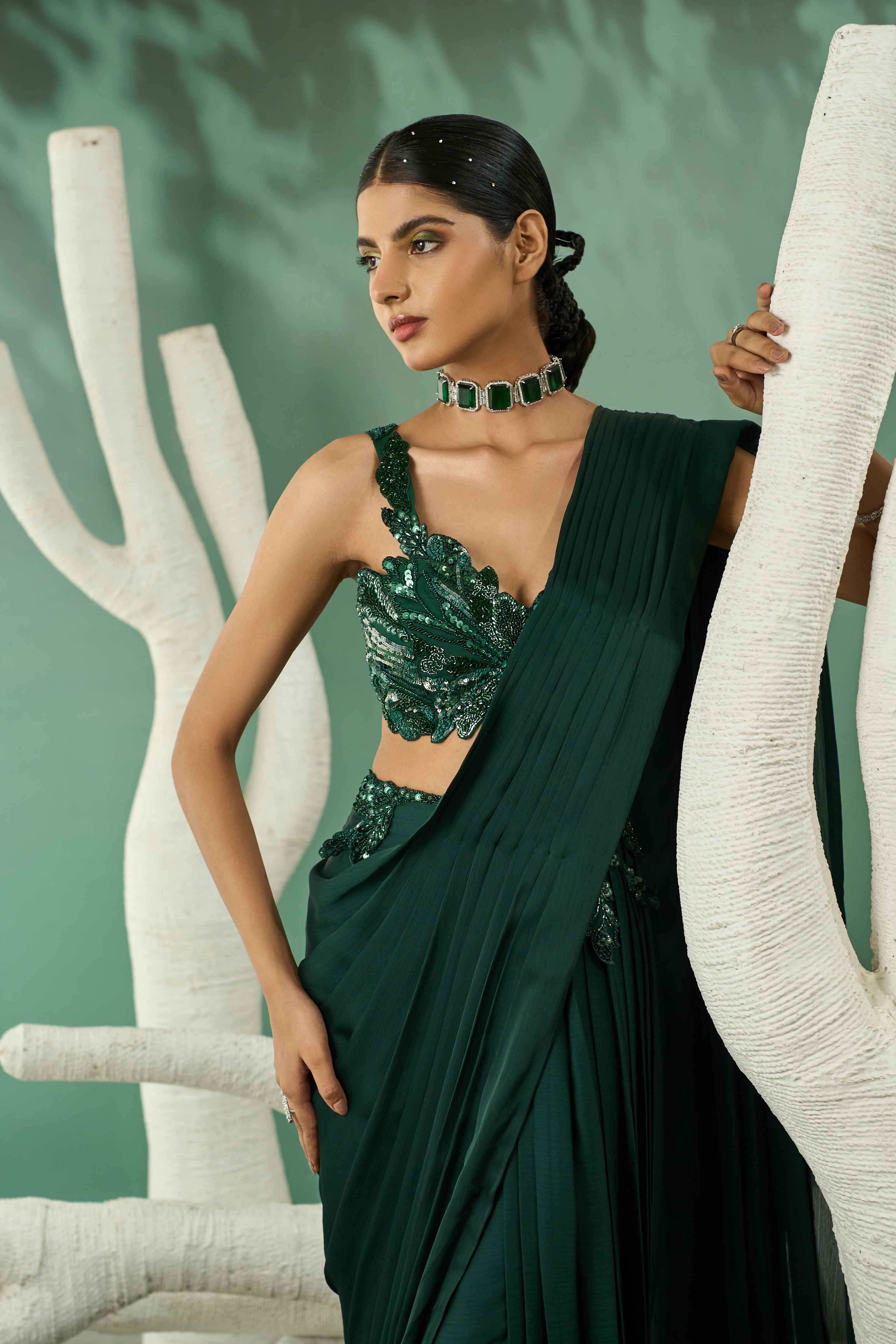 A model showcasing Emerald Green Cutwork Drape Saree Set by One Knot One from One Knot One's collection A model showcasing Emerald Green Cutwork Drape Saree Set by One Knot One from One Knot One's collection