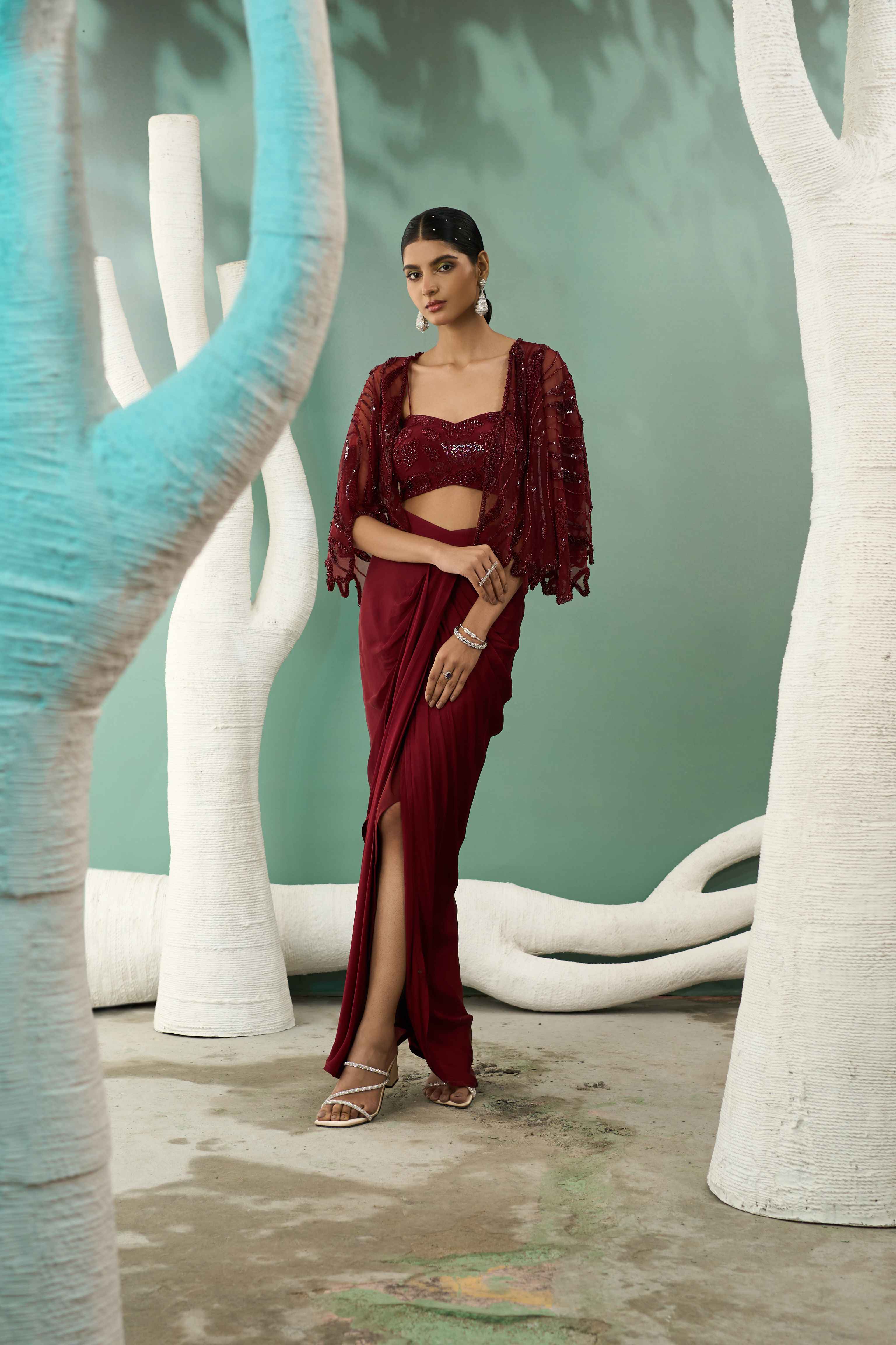 A model showcasing Burgundy Drape Skirt Shrug Set by One Knot One from One Knot One's collection