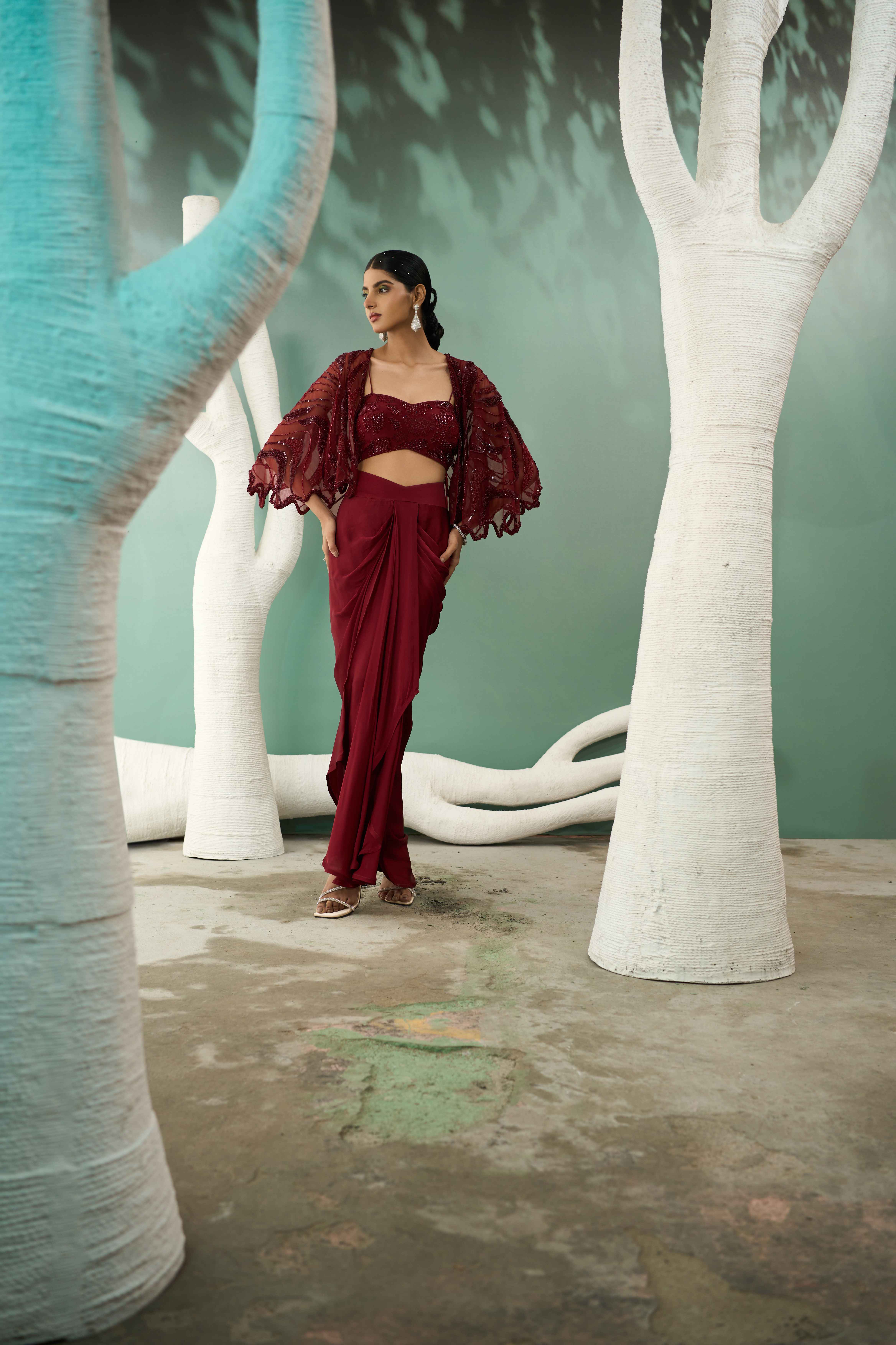 A model showcasing Burgundy Drape Skirt Shrug Set by One Knot One from One Knot One's collection