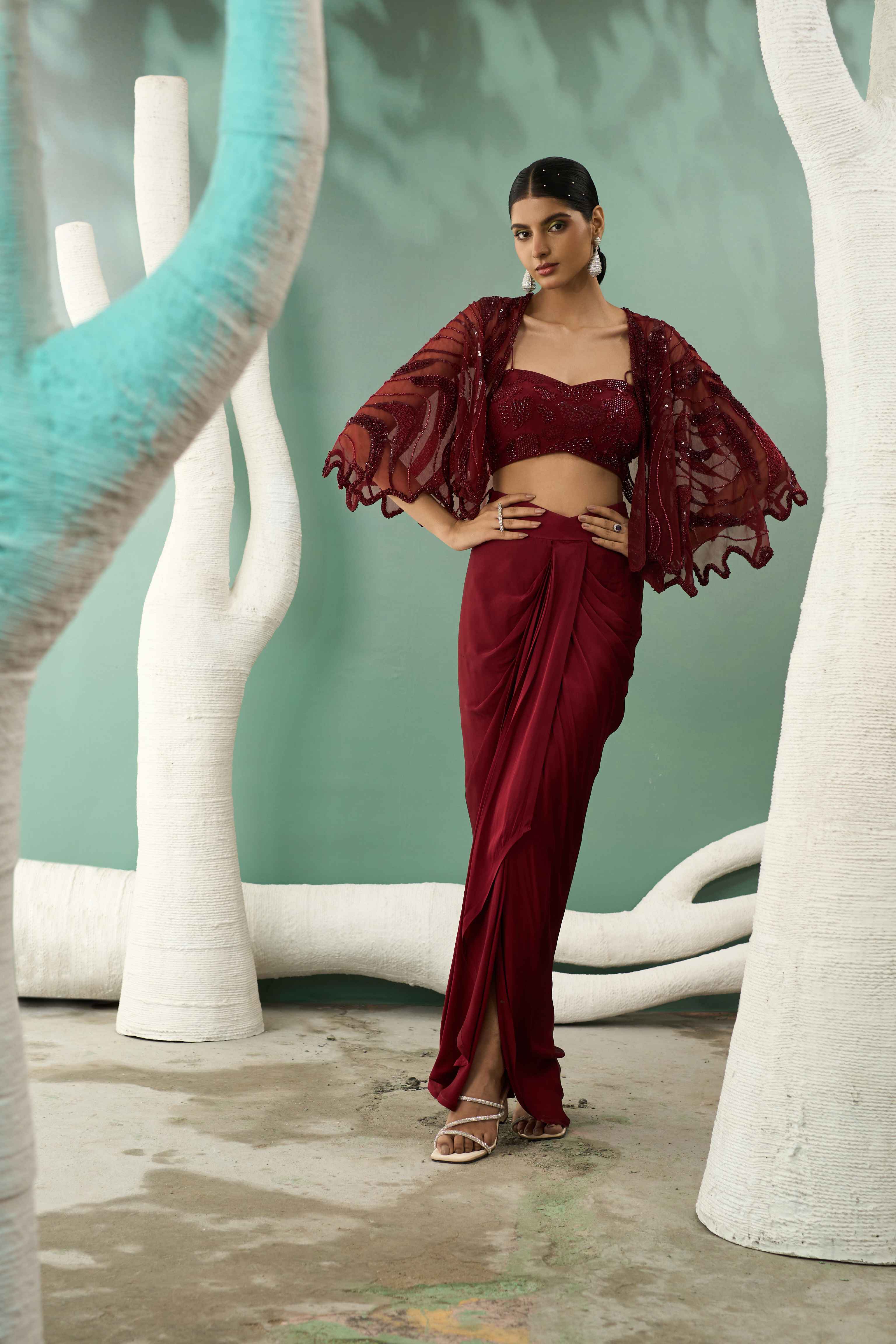 A model showcasing Burgundy Drape Skirt Shrug Set by One Knot One from One Knot One's collection
