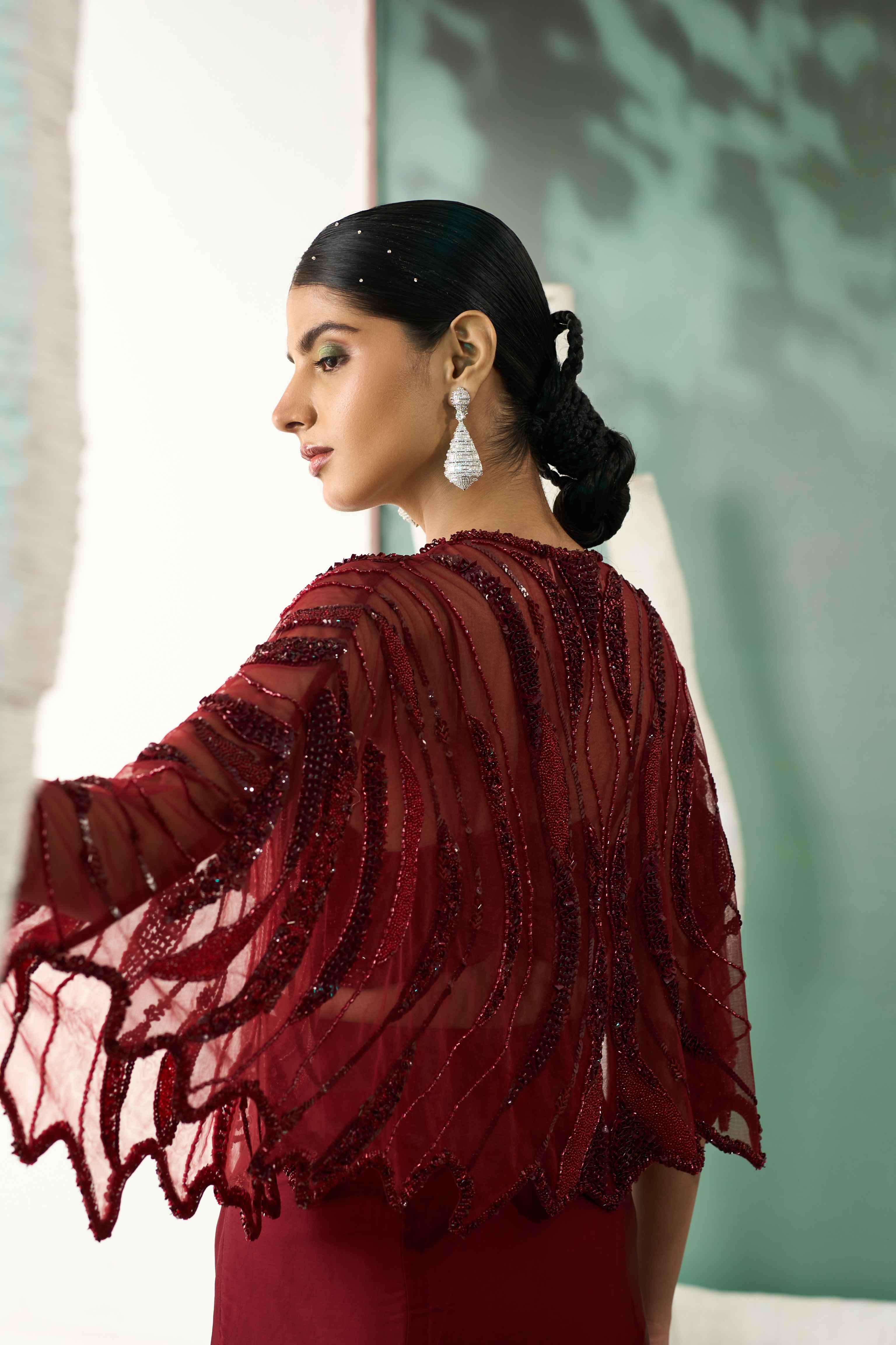 A model showcasing Burgundy Drape Skirt Shrug Set by One Knot One from One Knot One's collection