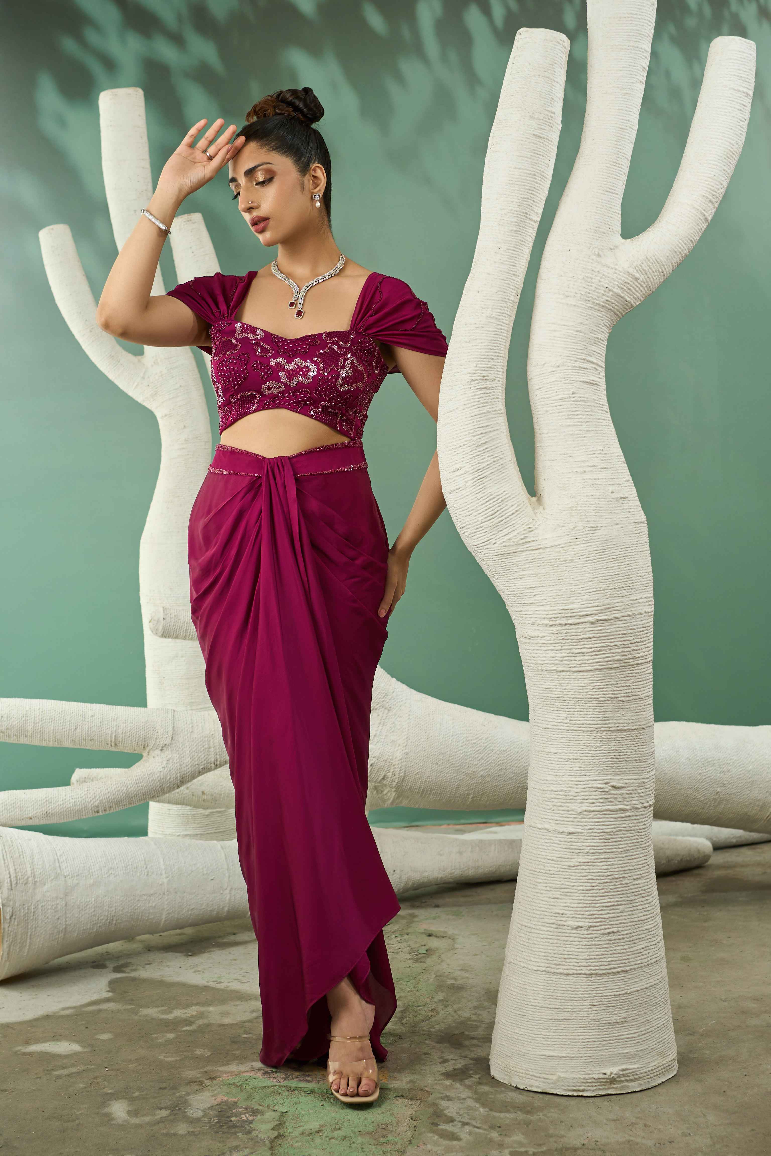 A model showcasing Plum Pink Drape Skirt Set by One Knot One from One Knot One's collection