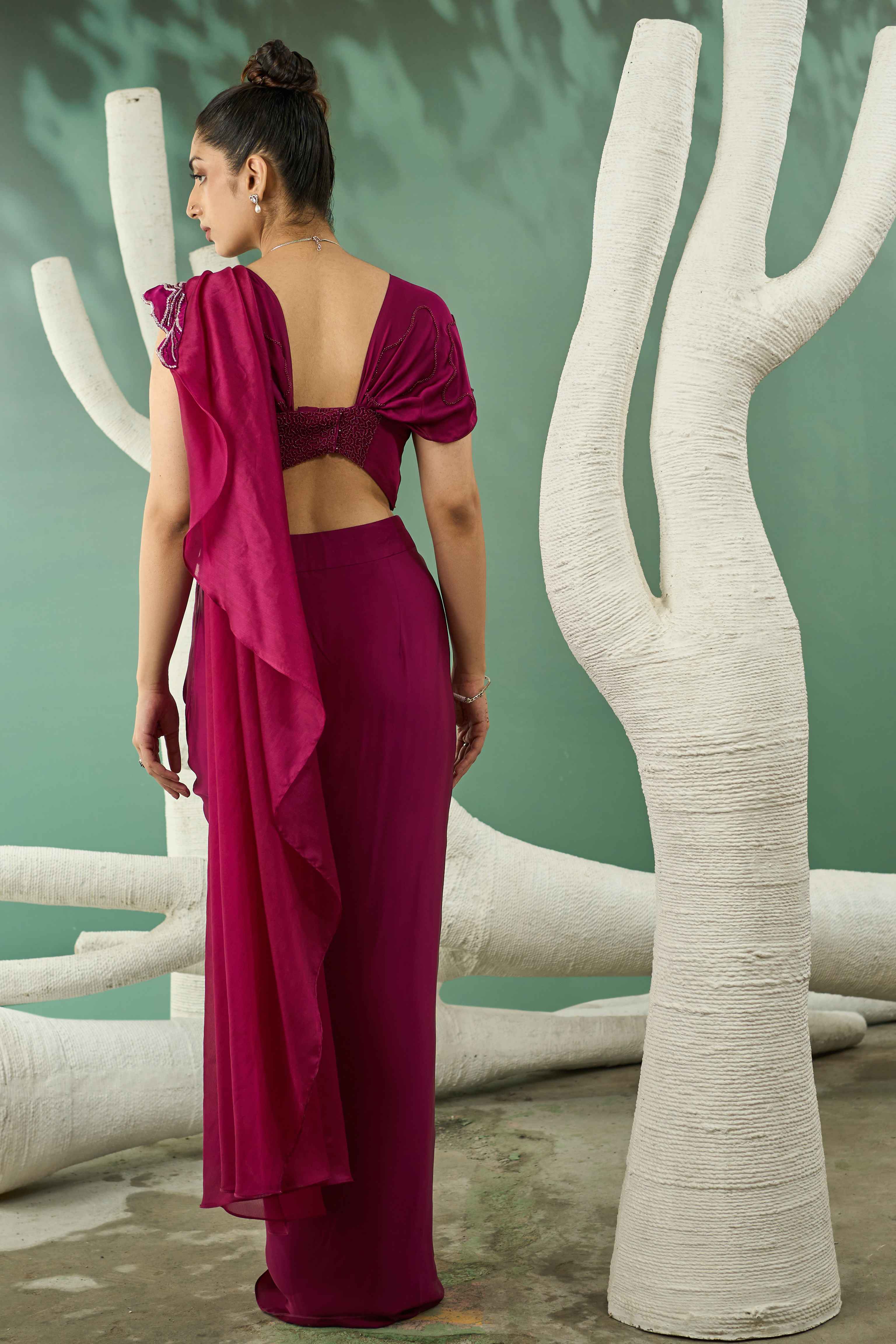 A model showcasing Plum Pink Drape Skirt Set With Detachable Dupatta by One Knot One from One Knot One's collection