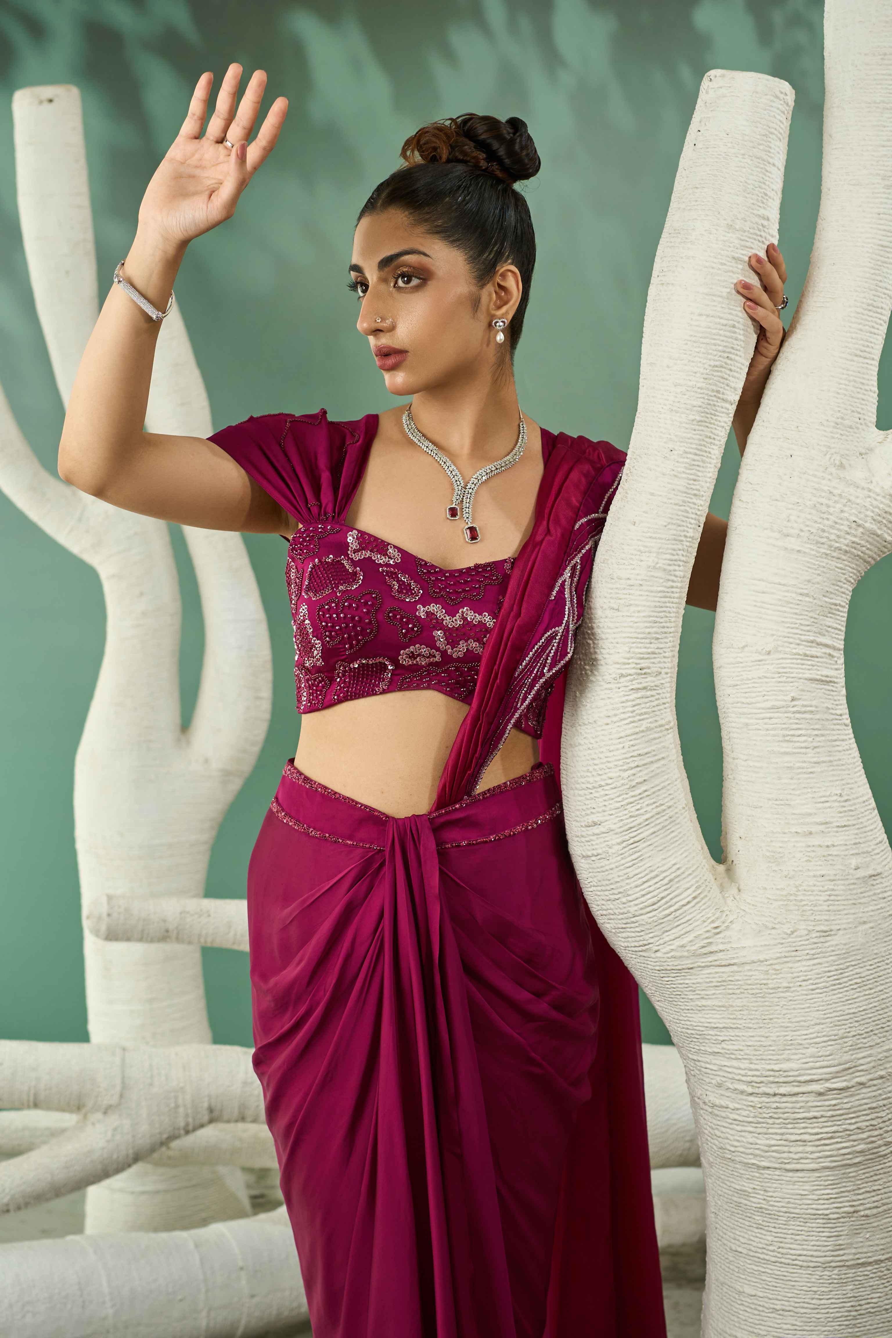 A model showcasing Plum Pink Drape Skirt Set With Detachable Dupatta by One Knot One from One Knot One's collection