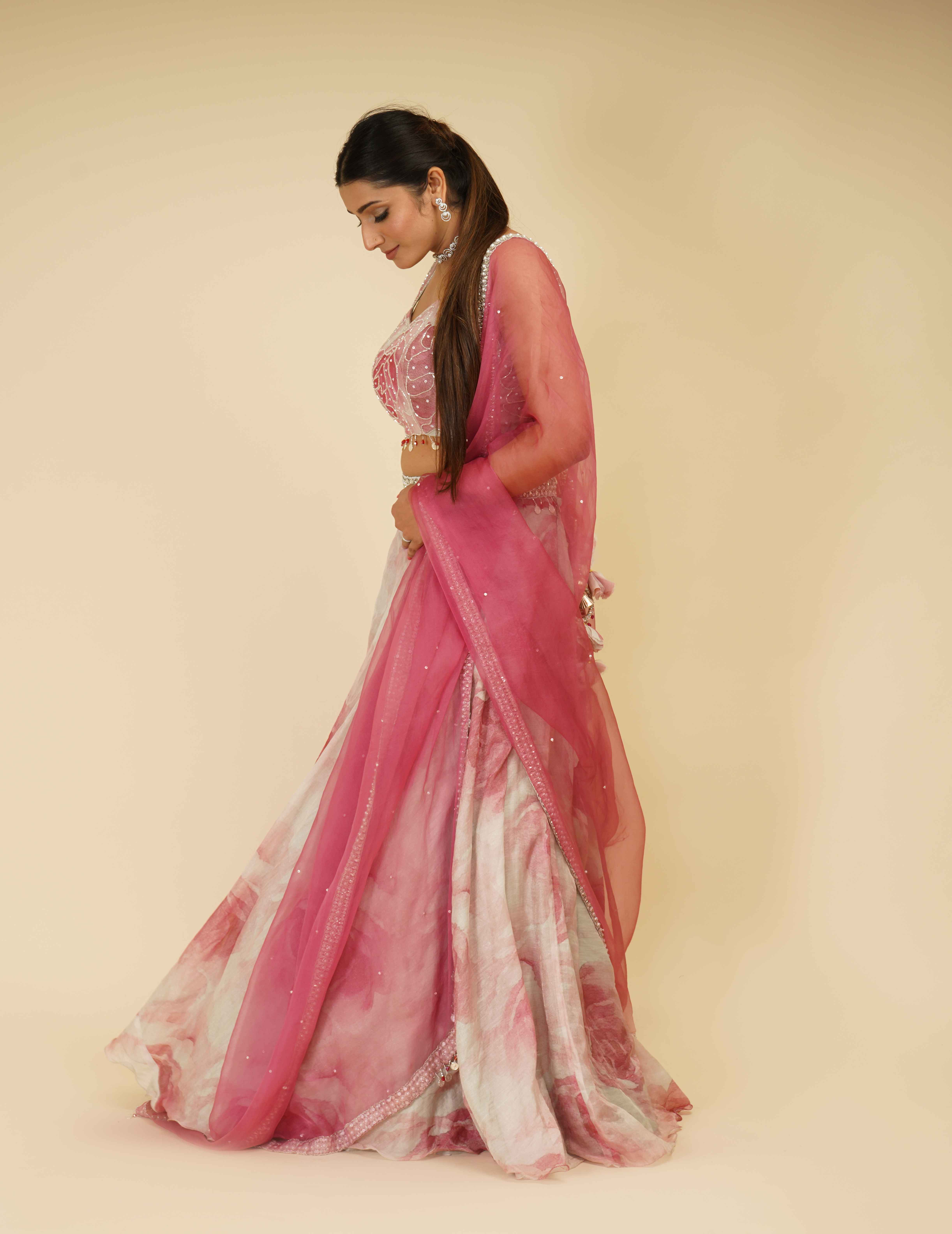 A model showcasing Elegant Flamingo Pink Embroidered Lehenga by Farha Syed from Farha Syed's collection
