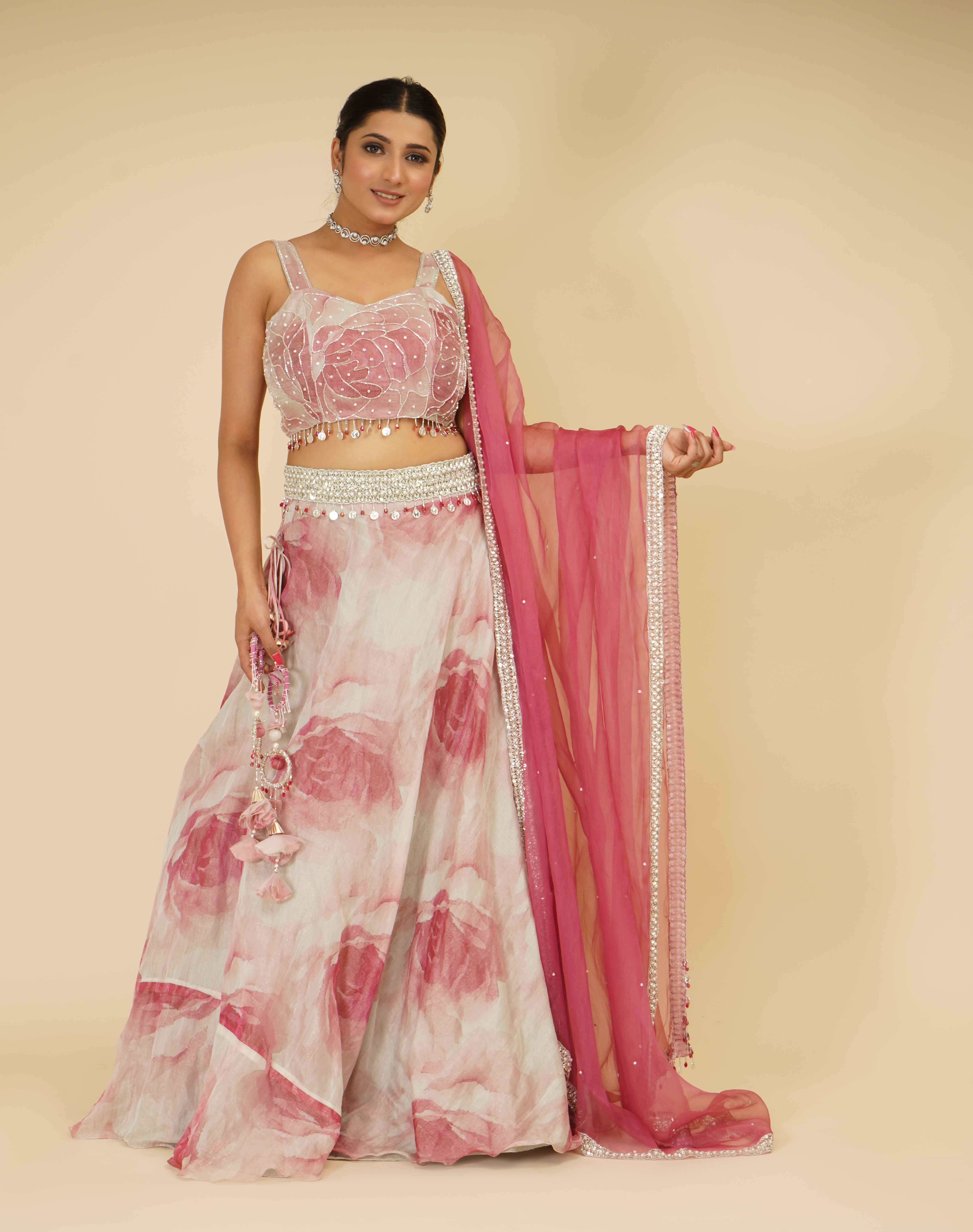 A model showcasing Elegant Flamingo Pink Embroidered Lehenga by Farha Syed from Farha Syed's collection