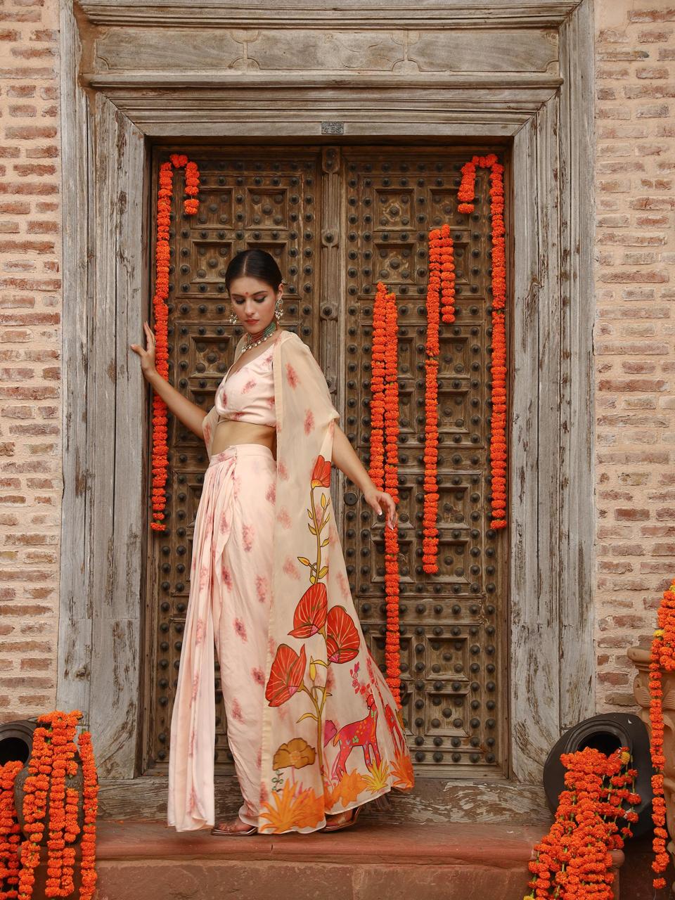 A model showcasing Levi Cape Skirt Set by Miku Kumar from Miku Kumar's collection