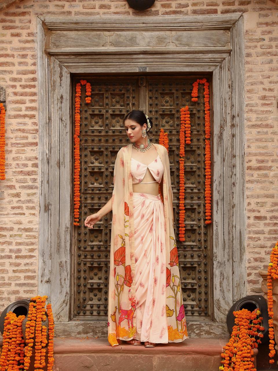 A model showcasing Levi Cape Skirt Set by Miku Kumar from Miku Kumar's collection