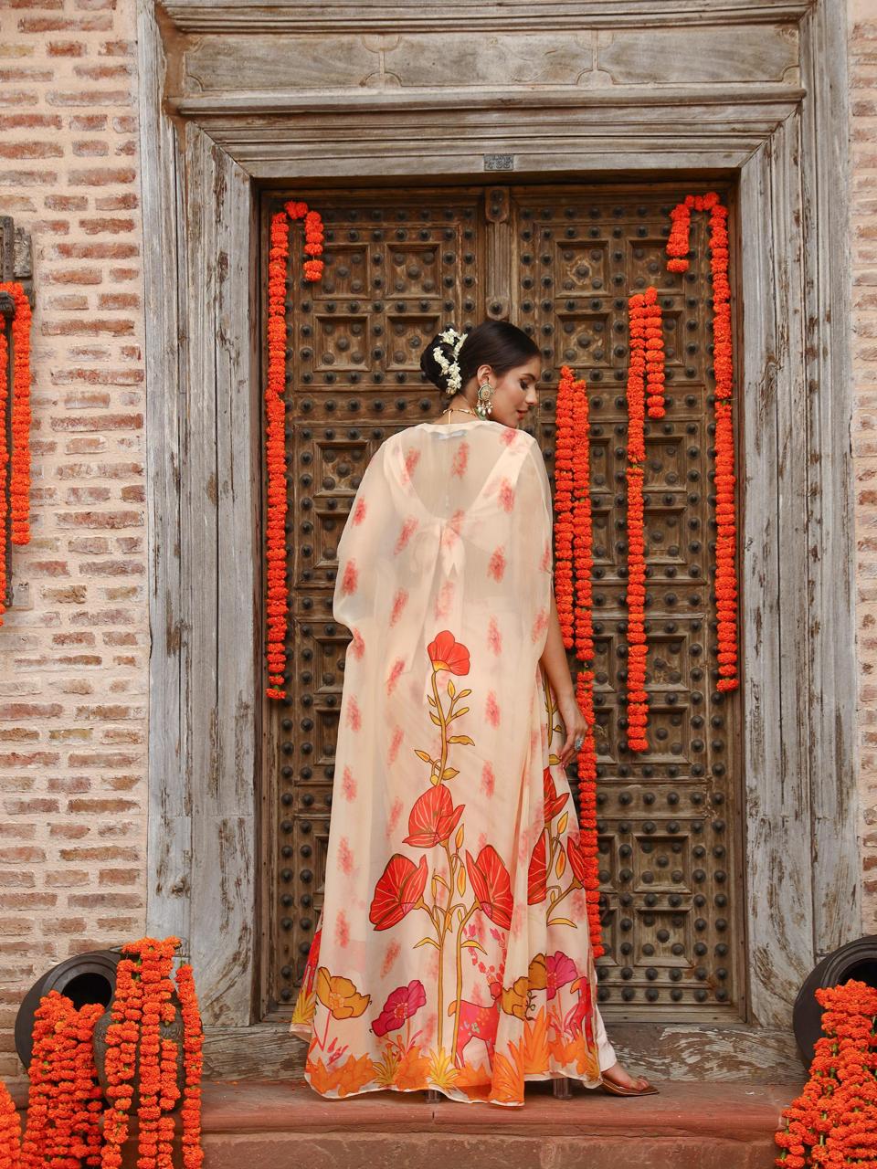 A model showcasing Levi Cape Skirt Set by Miku Kumar from Miku Kumar's collection