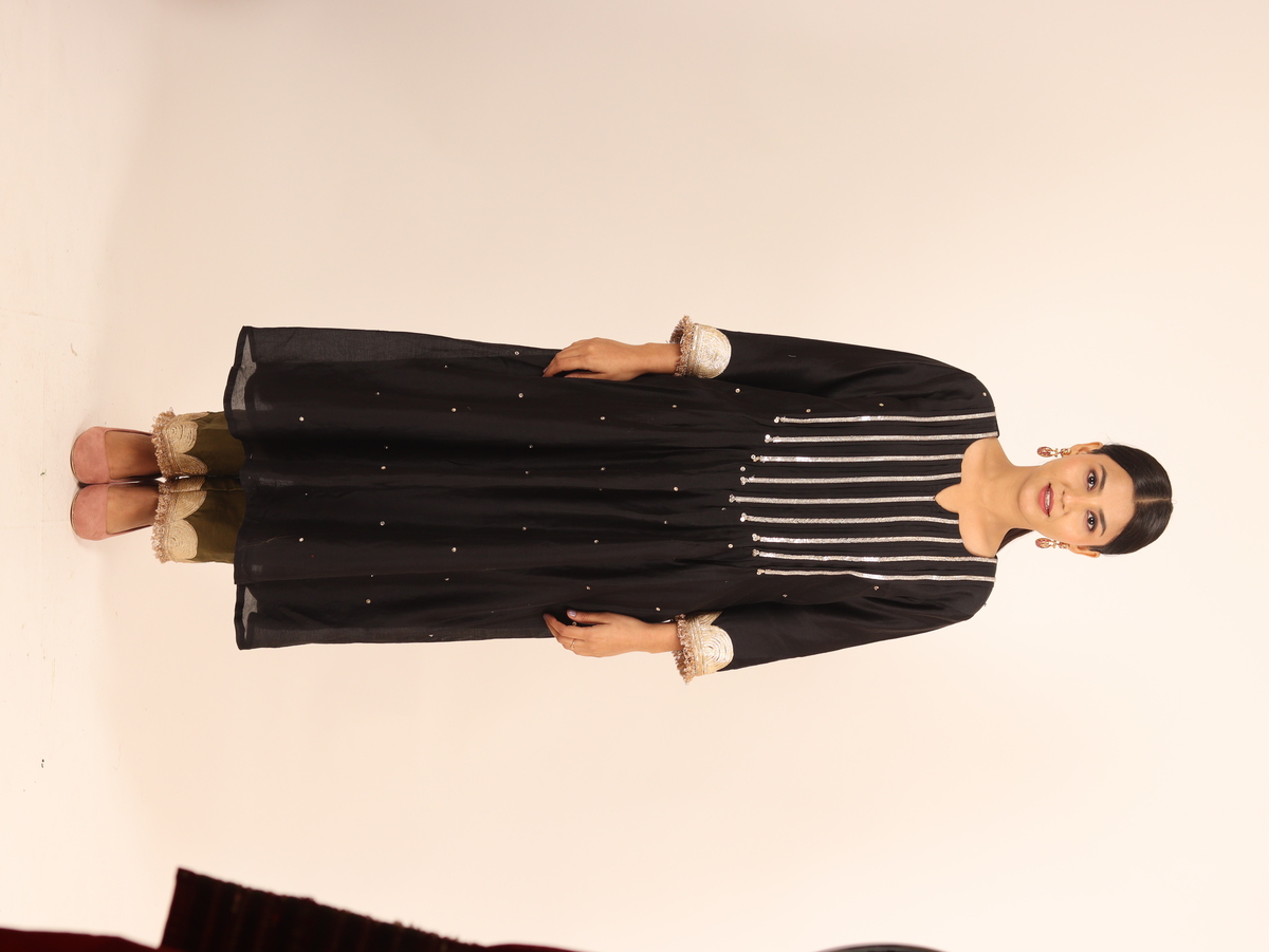 A model showcasing Black Chanderi Suit by Adivaa from Adivaa's collection A model showcasing Black Chanderi Suit by Adivaa from Adivaa's collection