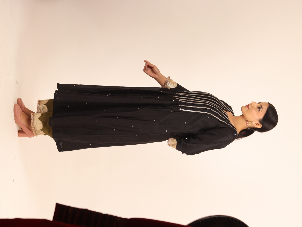 A model showcasing Black Chanderi Suit by Adivaa from Adivaa's collection A model showcasing Black Chanderi Suit by Adivaa from Adivaa's collection