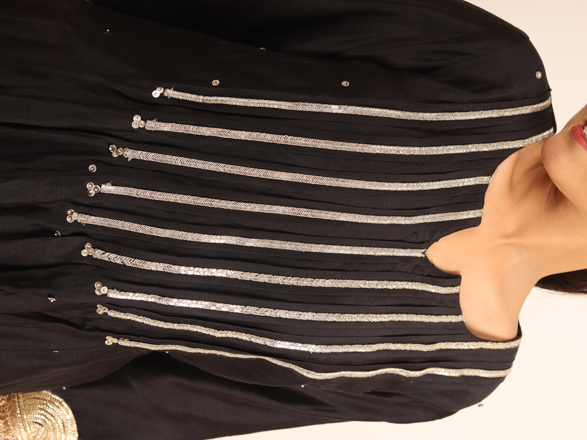 A model showcasing Black Chanderi Suit by Adivaa from Adivaa's collection A model showcasing Black Chanderi Suit by Adivaa from Adivaa's collection